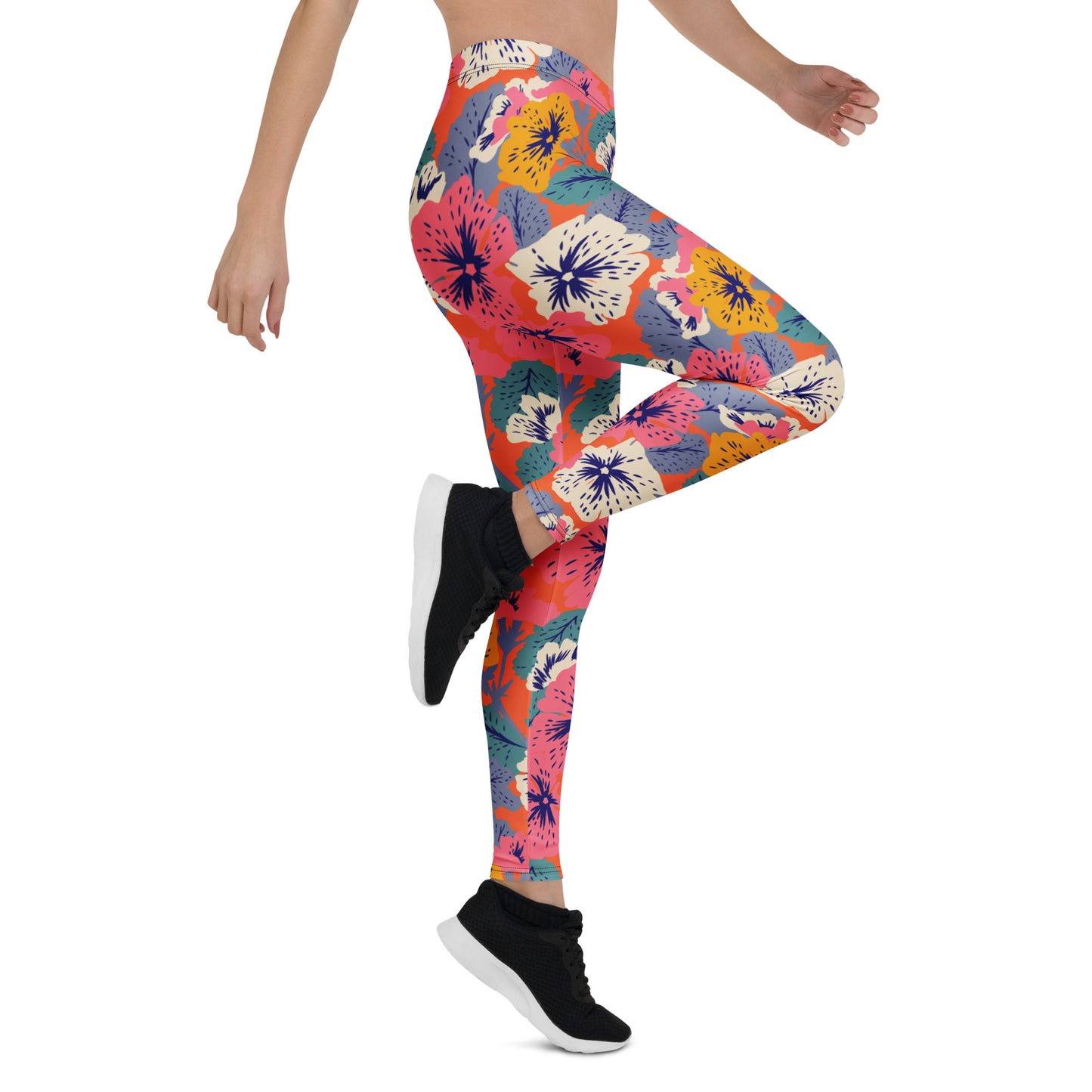 A model wearing colorful floral print leggings and black sneakers, cropped from the waist down, shown against a plain white background. Artistic Leggings Featuring Bold and Colorful Florals