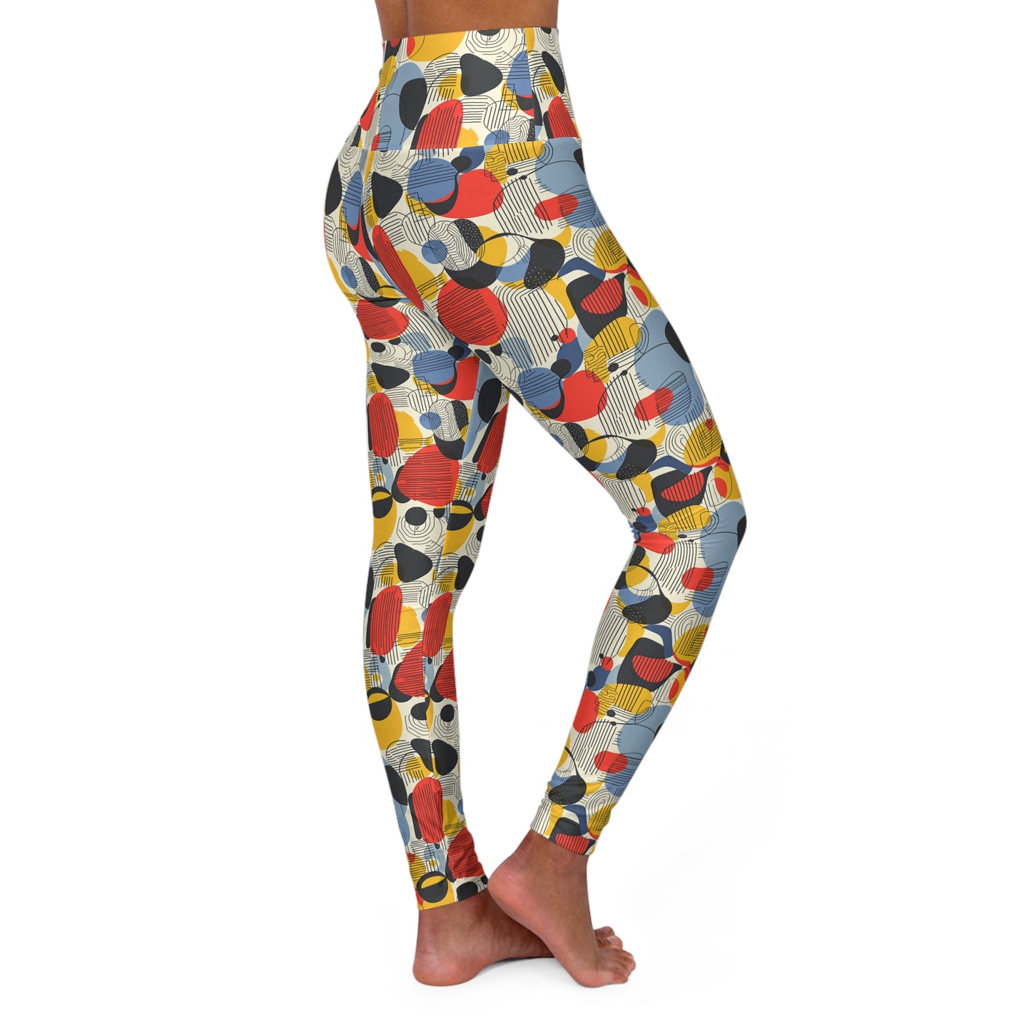 A person modeling high-waisted leggings with an abstract mid-century modern pattern of overlapping circles and stripes in red, yellow, blue, black, and white, shown from a side-back angle against a plain white background. Bold Minimalist Bauhaus Geometric Print Yoga Leggings Activewear