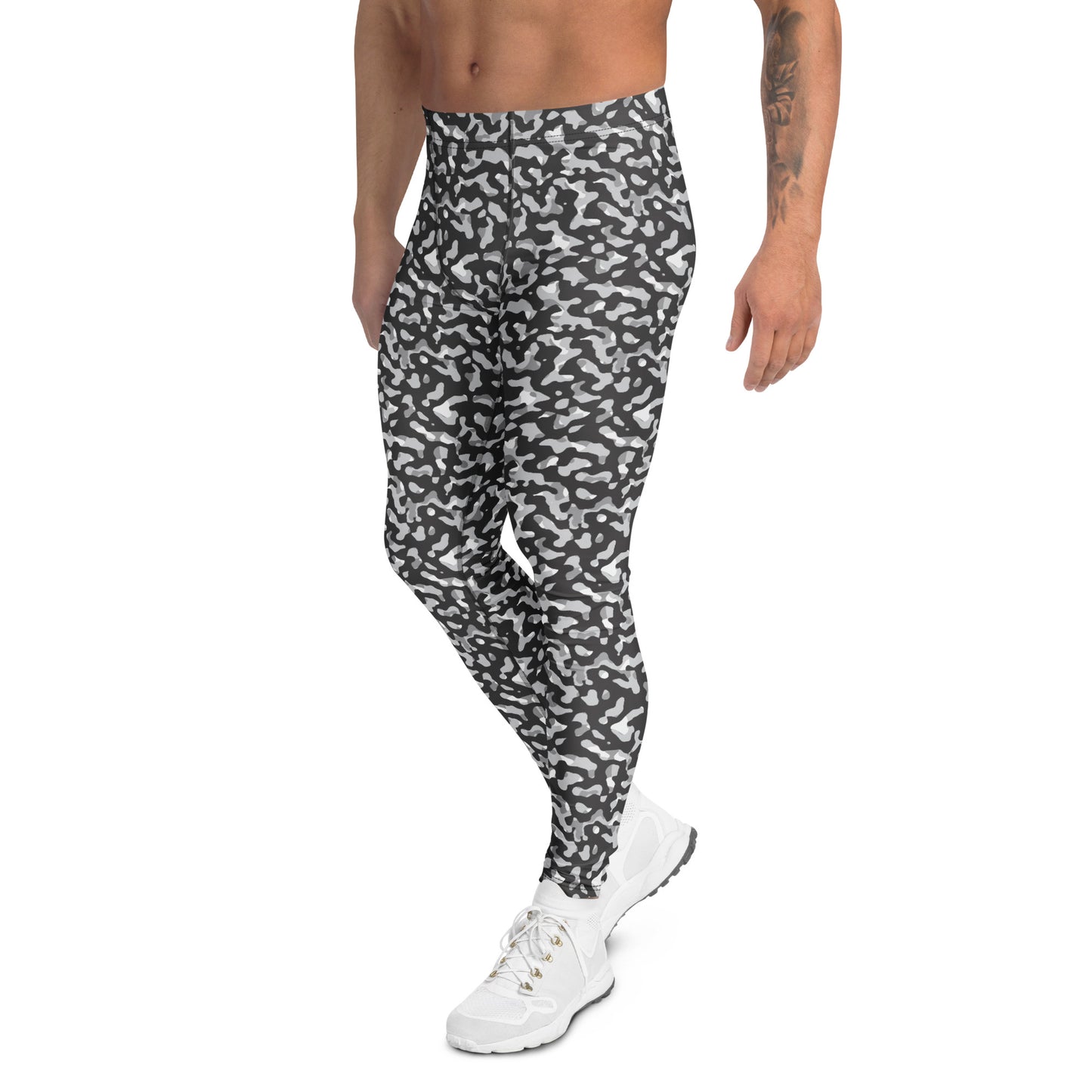 A man wearing high-waisted athletic leggings with a black and white abstract camouflage pattern, paired with white sneakers, shown from the waist down on a solid white background.