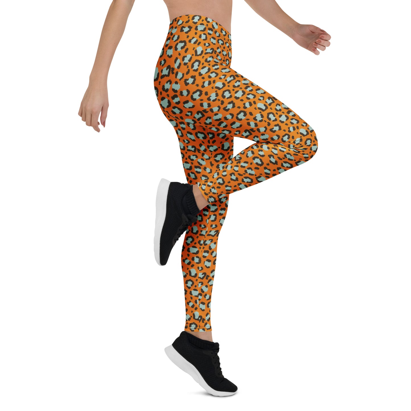 A model wearing high-waisted leggings with an orange, black, and teal leopard print, paired with black sneakers, shown from a side-rear angle against a white background. Chic Bold Leopard Print Leggings: A Wardrobe Essential Activewear