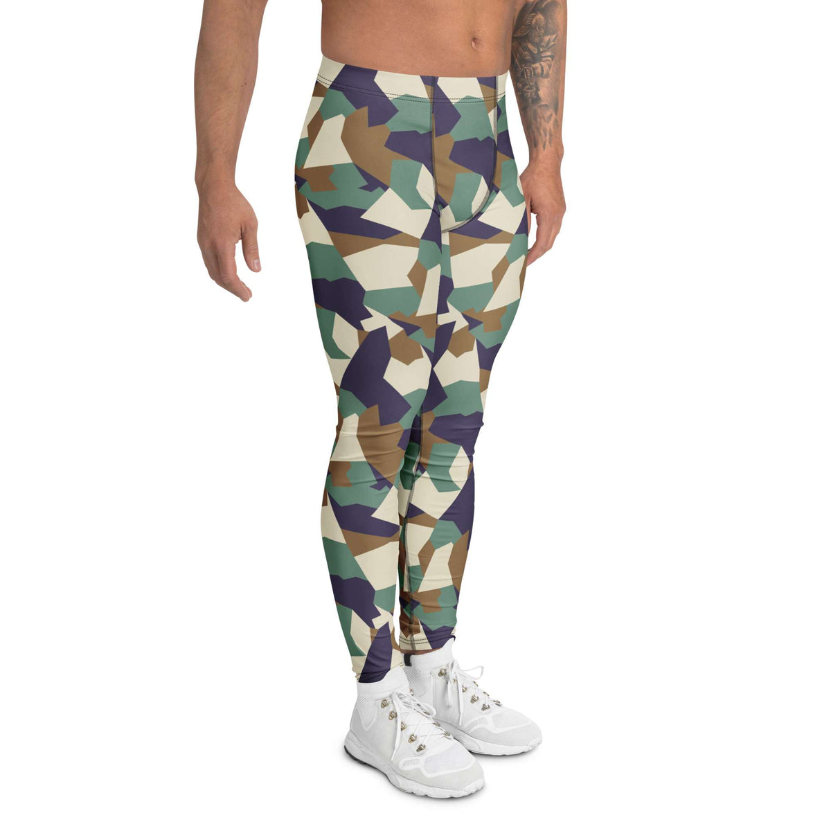 A model wearing high-waisted camouflage leggings with a geometric pattern in green, brown, navy, and beige, paired with white sneakers against a plain white background. Bold Colorful Camouflage Geometric Men's Leggings Activewear Shop Bold Colorful Camouflage Geometric Men's Leggings with a standout print, flexible fit, and all-day comfort for workouts or streetwear.