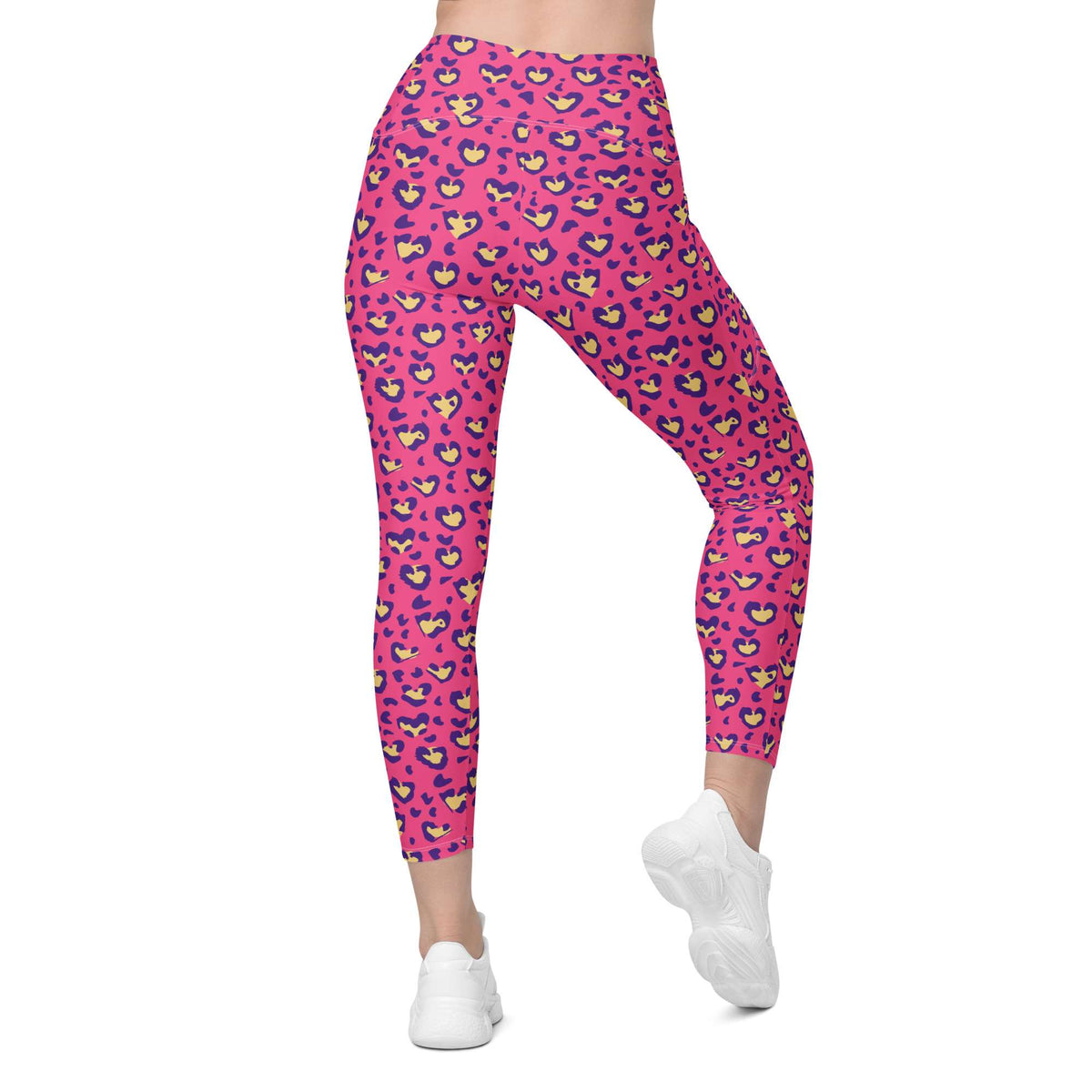 Pink high-waisted leggings with a colorful cartoon face pattern, shown on a model from the waist down wearing white sneakers against a plain white background. Heart Pink Leopard Pattern Leggings with Pockets Activewear Shop Heart Pink Leopard Pattern Leggings with Pockets Activewear, designed for bold workouts, everyday comfort, and convenient storage. Upgrade your workout wardrobe with Heart Pink Leopard Pattern Leggings with Pockets Activewear—stylish, practical, and made to move.