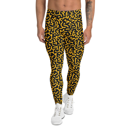 A person modeling high-waisted leggings with a bold yellow and black abstract wavy pattern, paired with white sneakers against a plain white background.