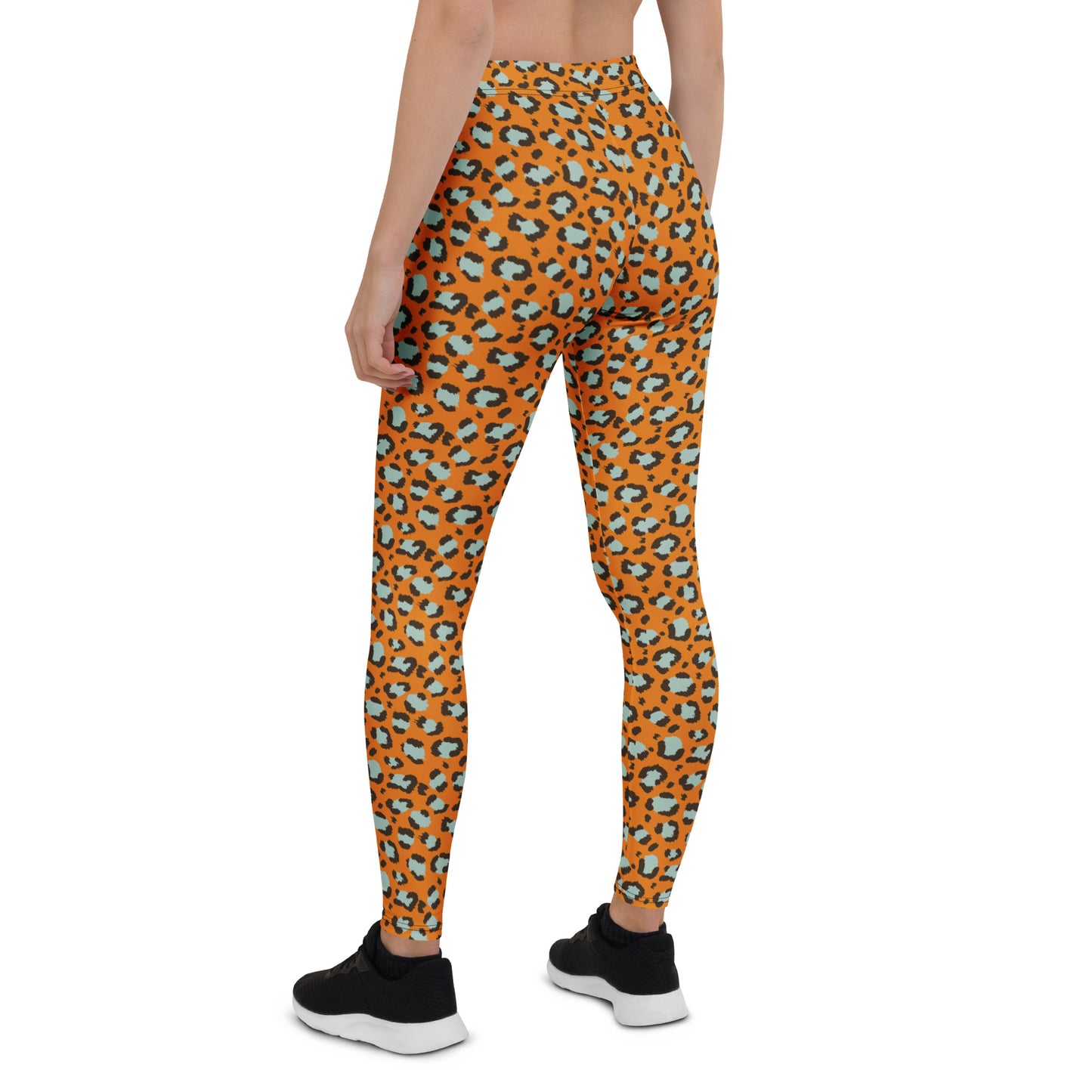 A model from the back wearing high-waisted leggings with an orange, black, and light blue leopard print pattern, paired with black sneakers on a white background. Bold Leopard Print Leggings: A Wardrobe Essential for Activewear