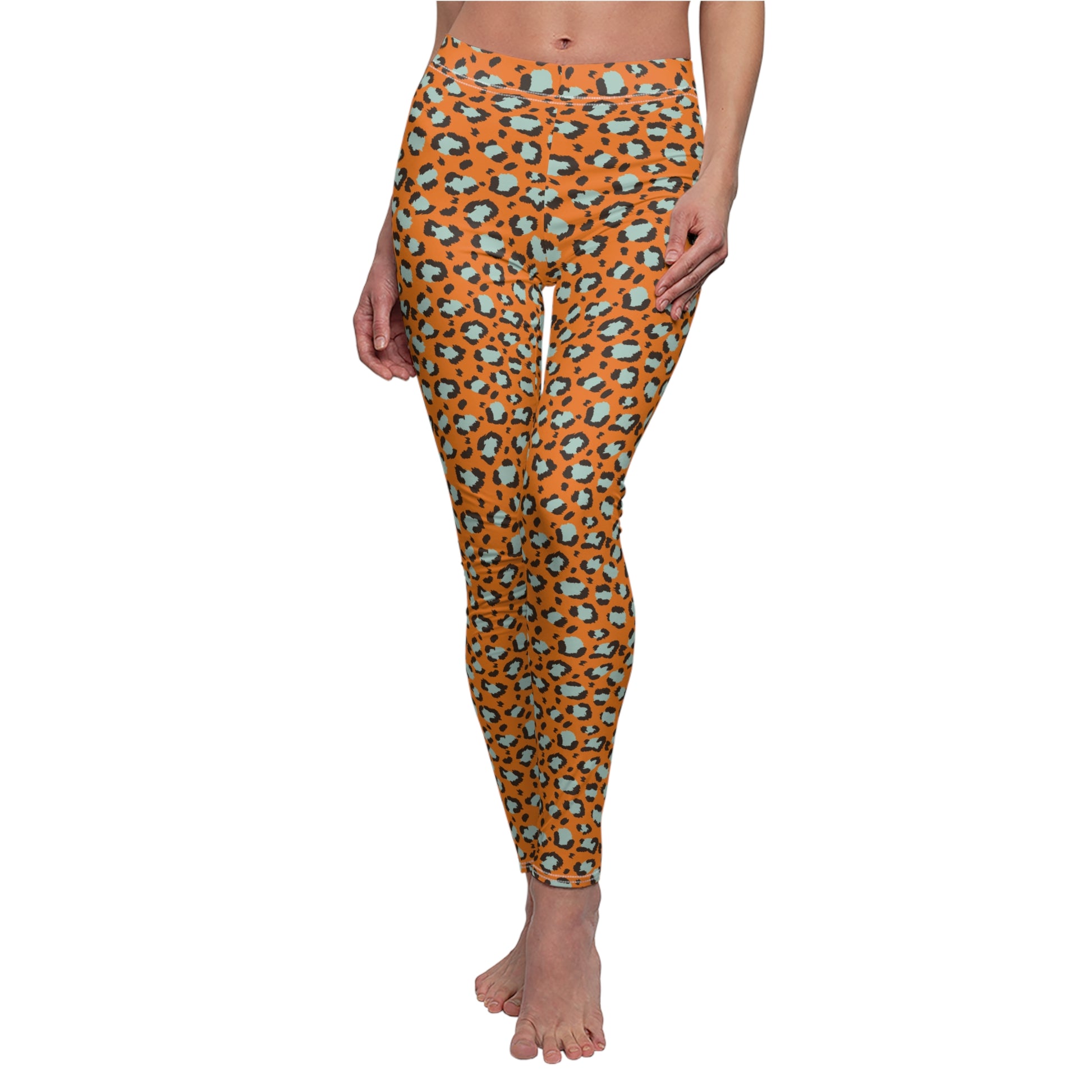 A person modeling high-waisted leggings with an orange leopard print pattern featuring black and light blue spots, shown against a plain white background. Bold Orange Leopard Print Women's Casual Leggings