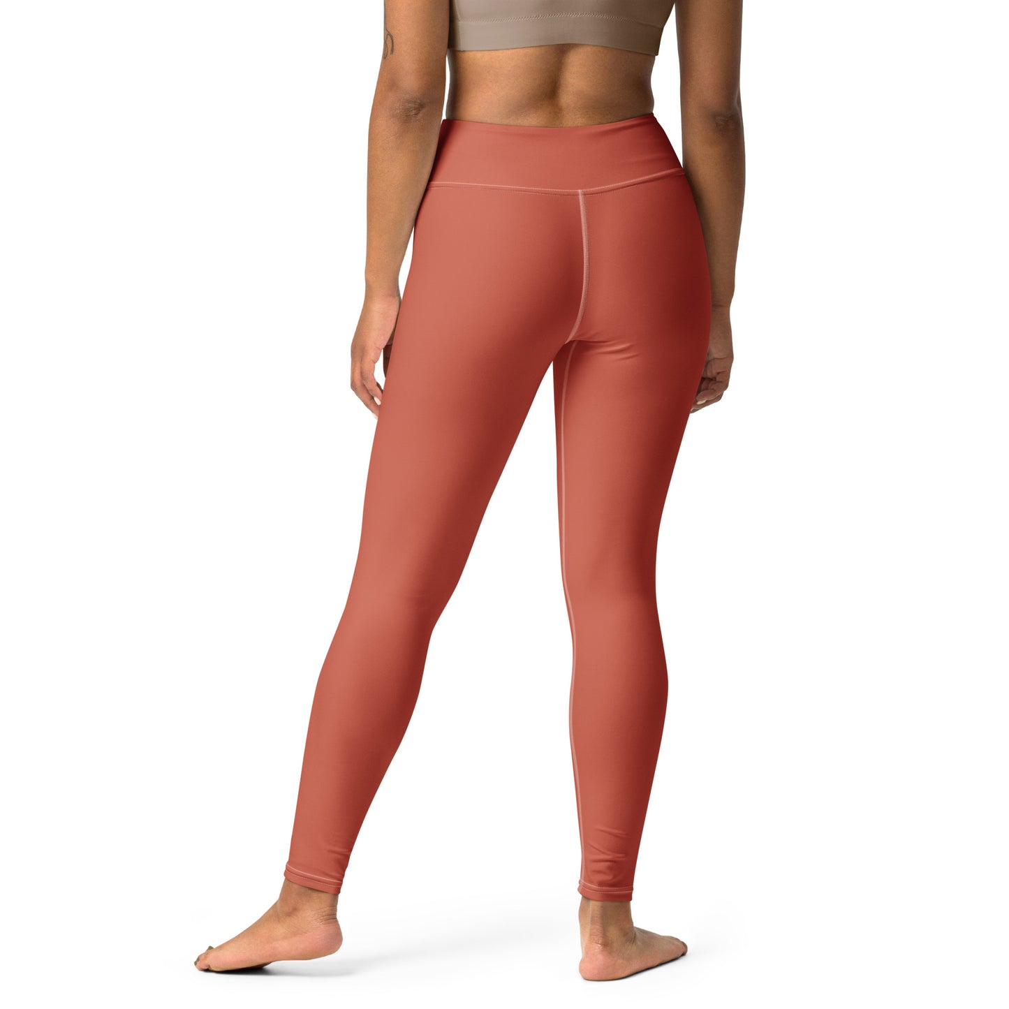 Rust-colored high-waisted leggings shown on a model from a rear three-quarter view against a plain white background. Bold Stretchy Yoga Leggings with Solid Dark Coral Stylish