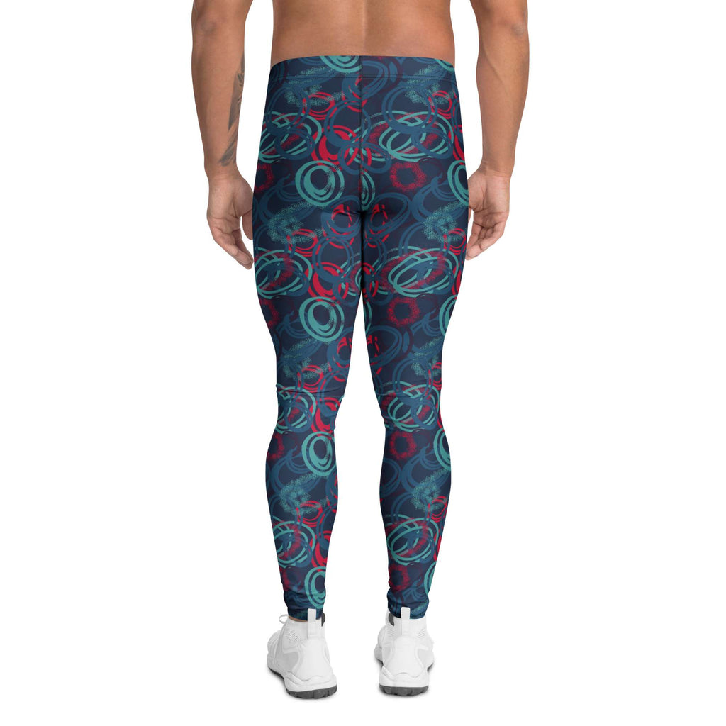 A person shown from the back wearing patterned leggings with a dark navy base and abstract teal and red circular swirls, paired with white sneakers on a plain white background. Bold Vibrant Geometric Shapes Men's Athletic Leggings Activewear