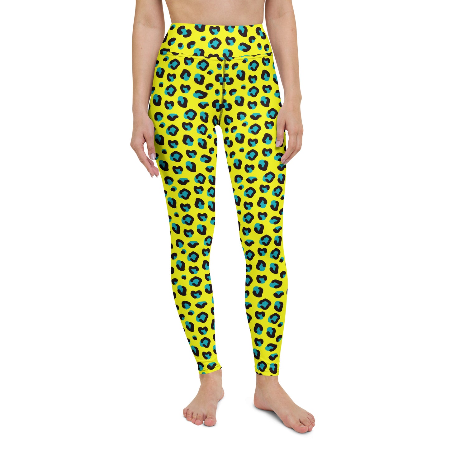 A person modeling bright yellow leggings with an allover blue and black leopard-style spot pattern, shown against a plain white studio background. Bold Yellow Teal Leopard Print Yoga Leggings for Activewear
