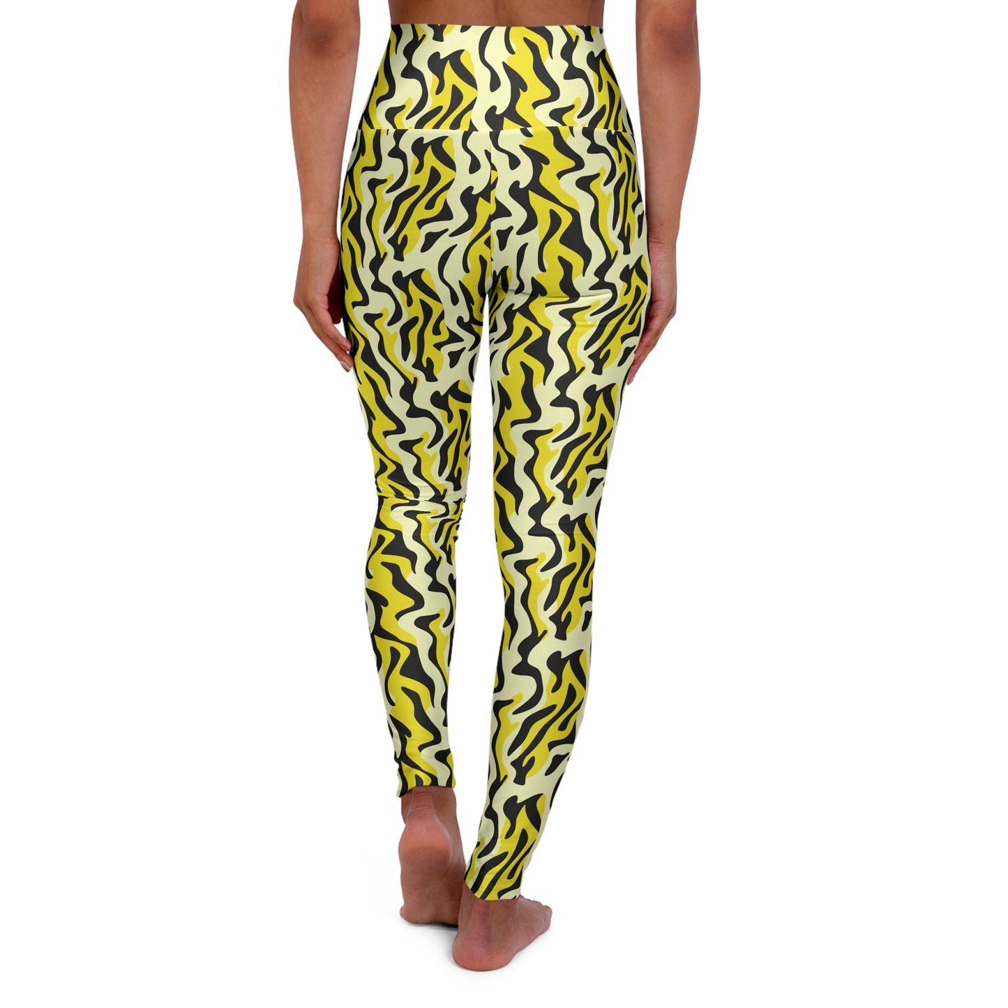 A person shown from the back wearing high-waisted leggings with a bold wavy abstract pattern in yellow, black, and off-white, standing barefoot against a plain white background. Bold Yellow and Black Zebra Print Yoga Leggings Active Wear