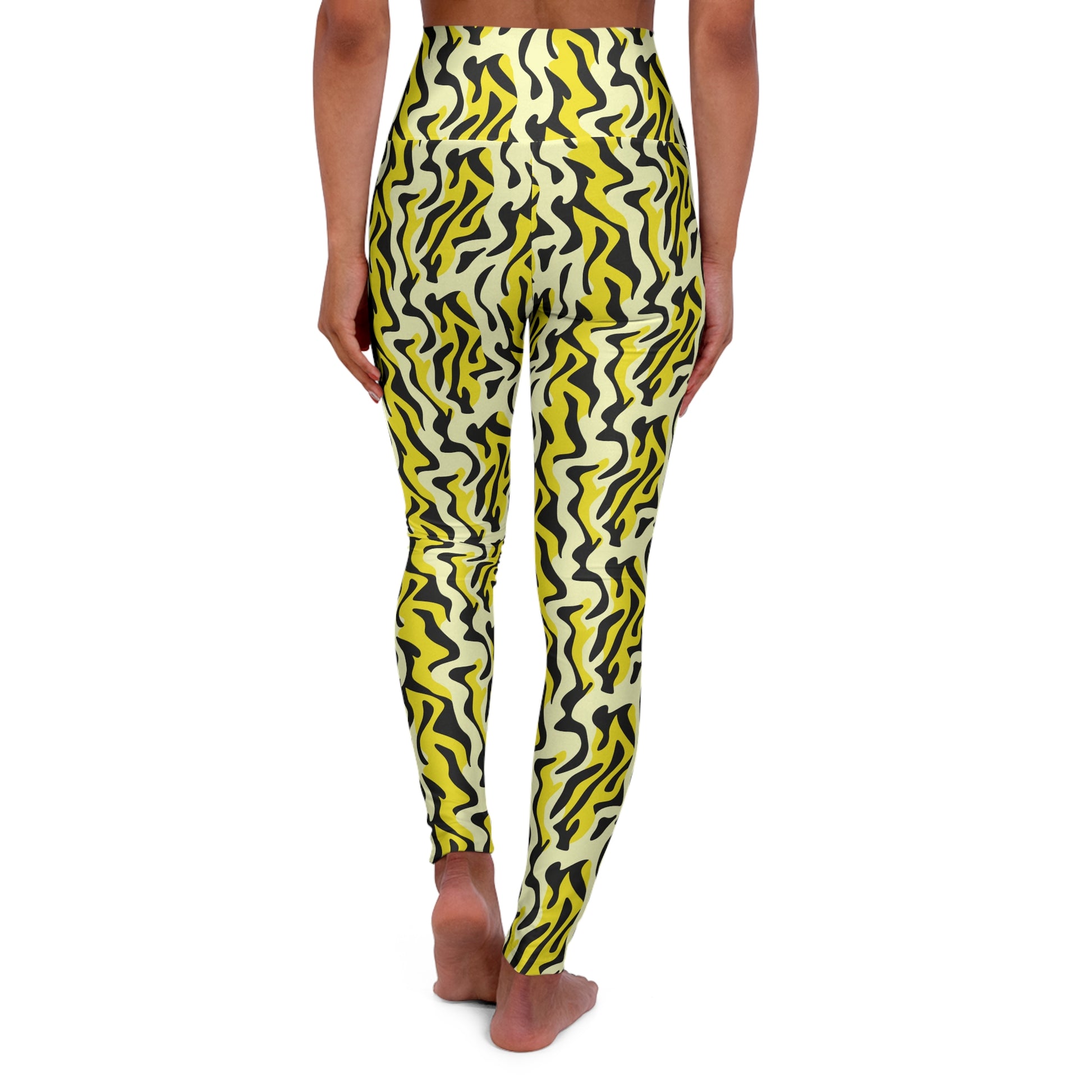 A person shown from the back wearing high-waisted leggings with a bold wavy abstract pattern in yellow, black, and off-white, standing barefoot against a plain white background. Bold Yellow and Black Zebra Print Yoga Leggings Active Wear