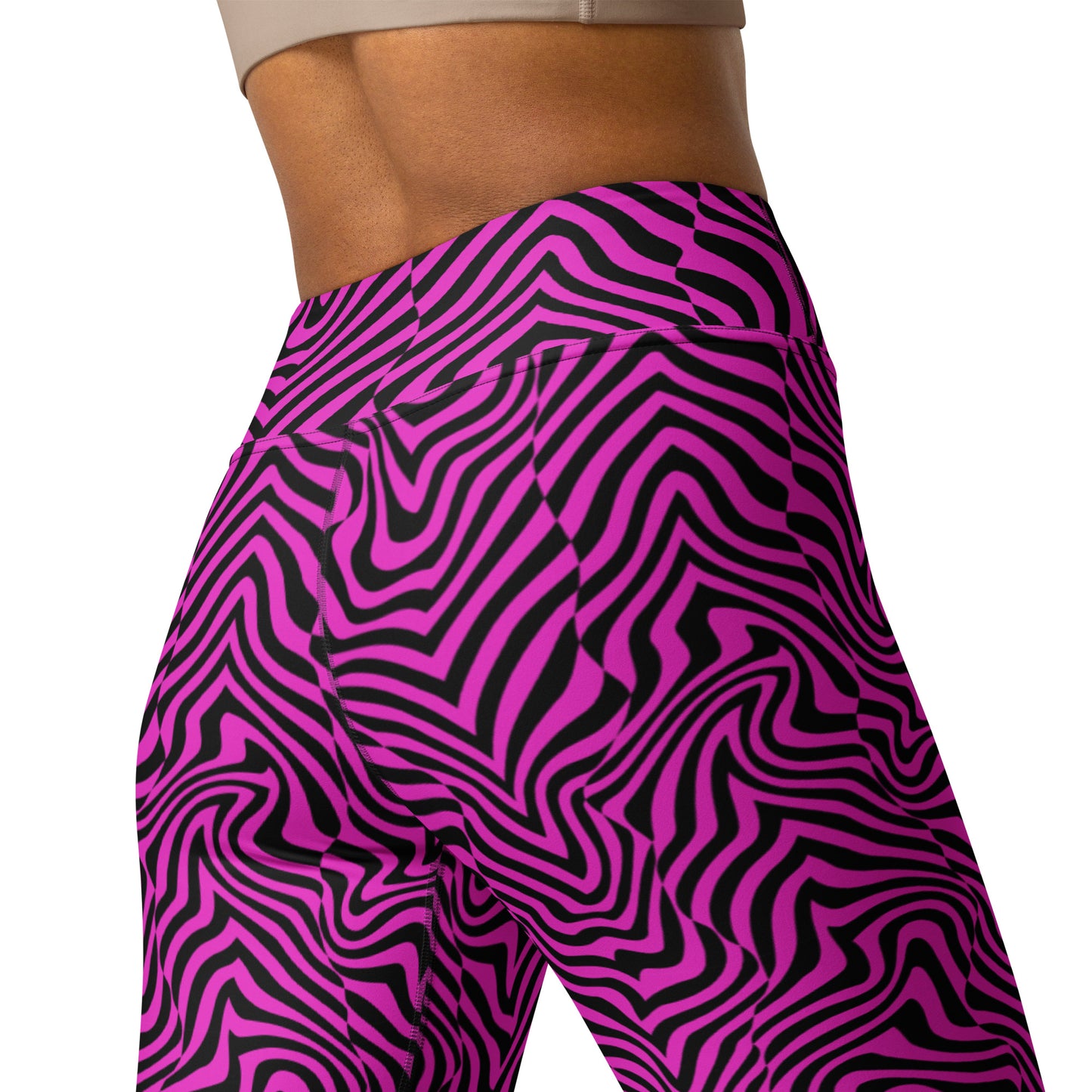 Close-up of a person wearing high-waisted leggings with a bold pink and black wavy zebra-like pattern, shown from the waist to upper thigh on a white background. Chic Bold Fashion Yoga Leggings Modern Psychedelic Art Activewear