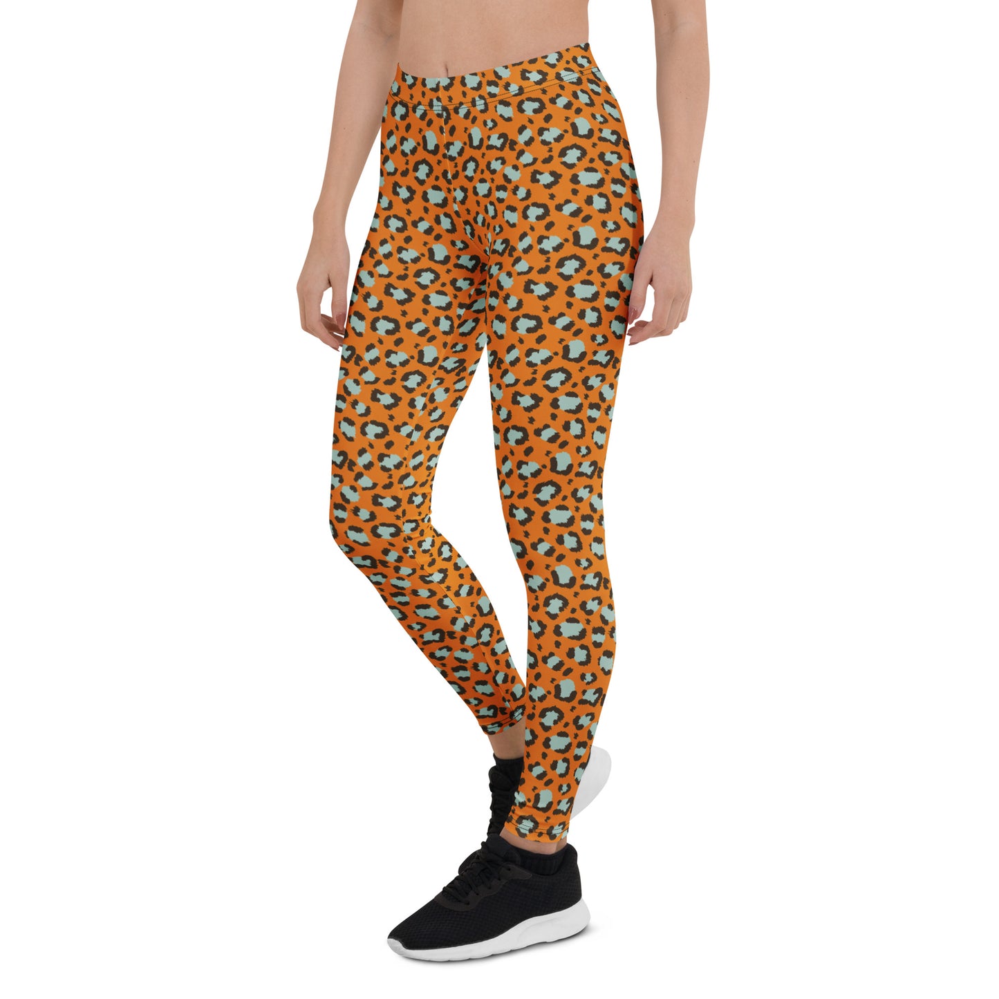 A model wearing high-waisted leggings with an orange, black, and light blue leopard print pattern, paired with black sneakers, shown against a plain white background. Chic Bold Leopard Print Leggings: A Wardrobe Essential for Activewear