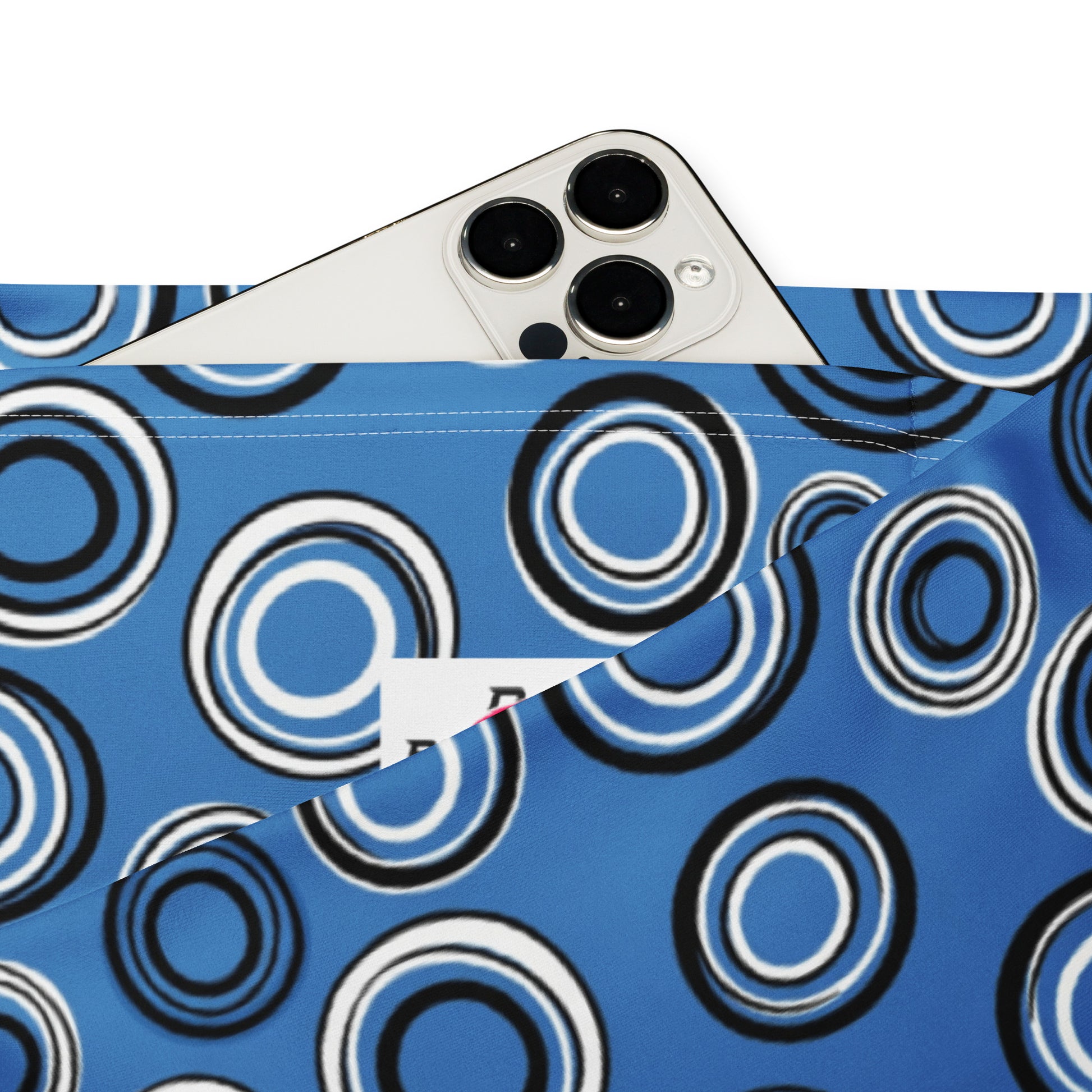 A close-up of a blue fabric pouch or pocket with a black and white concentric circle pattern, shown with a silver smartphone partially tucked inside on a white background. Chic Celestial Planetary Orbit Pattern Flare Leggings Activewear