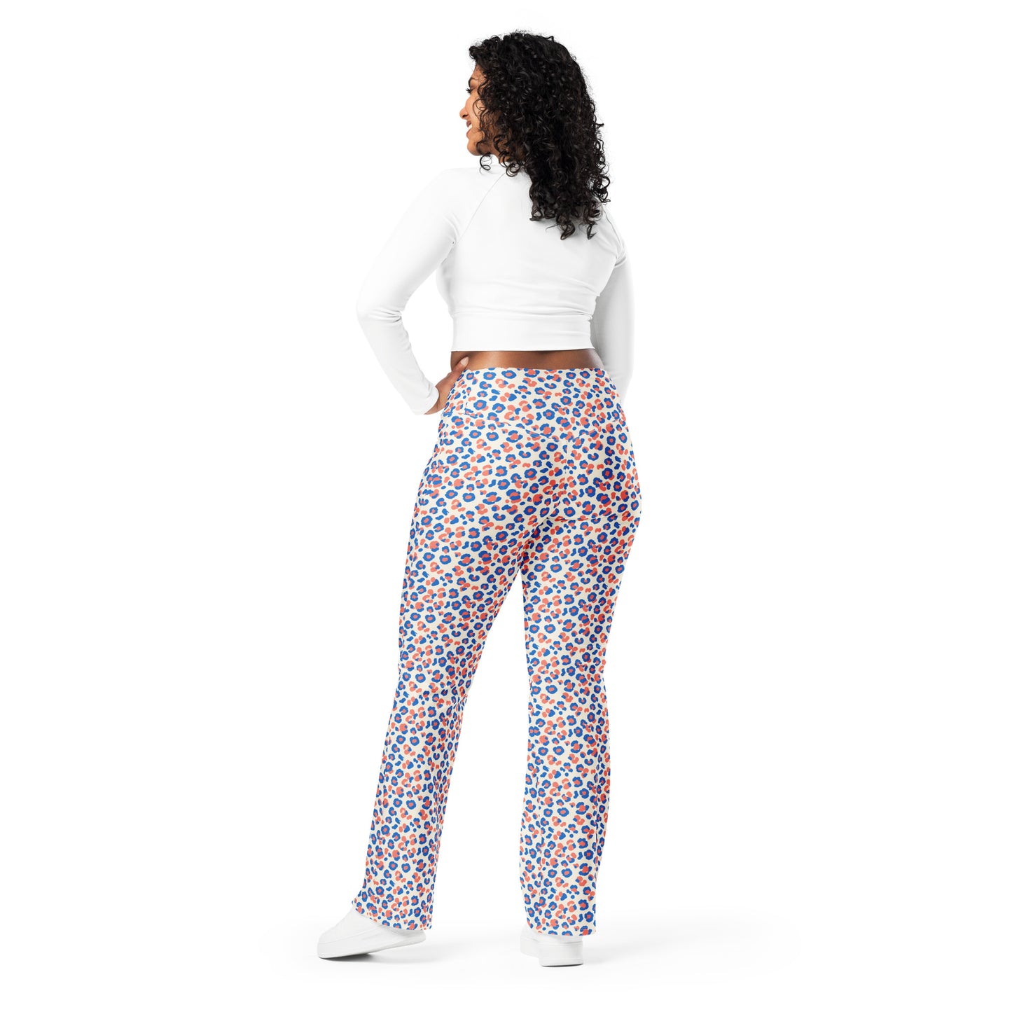 A woman is shown from the back wearing high-waisted, wide-leg pants with a colorful blue, orange, and white pattern, paired with a white long-sleeve crop top and white sneakers, on a solid white background. Chic Colorful Leopard Print Flare Leggings Active Wear