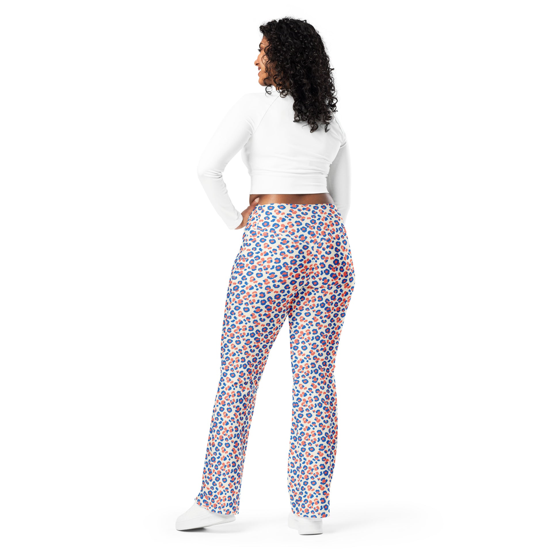 A woman is shown from the back wearing high-waisted, wide-leg pants with a colorful blue, orange, and white pattern, paired with a white long-sleeve crop top and white sneakers, on a solid white background. Chic Colorful Leopard Print Flare Leggings Active Wear