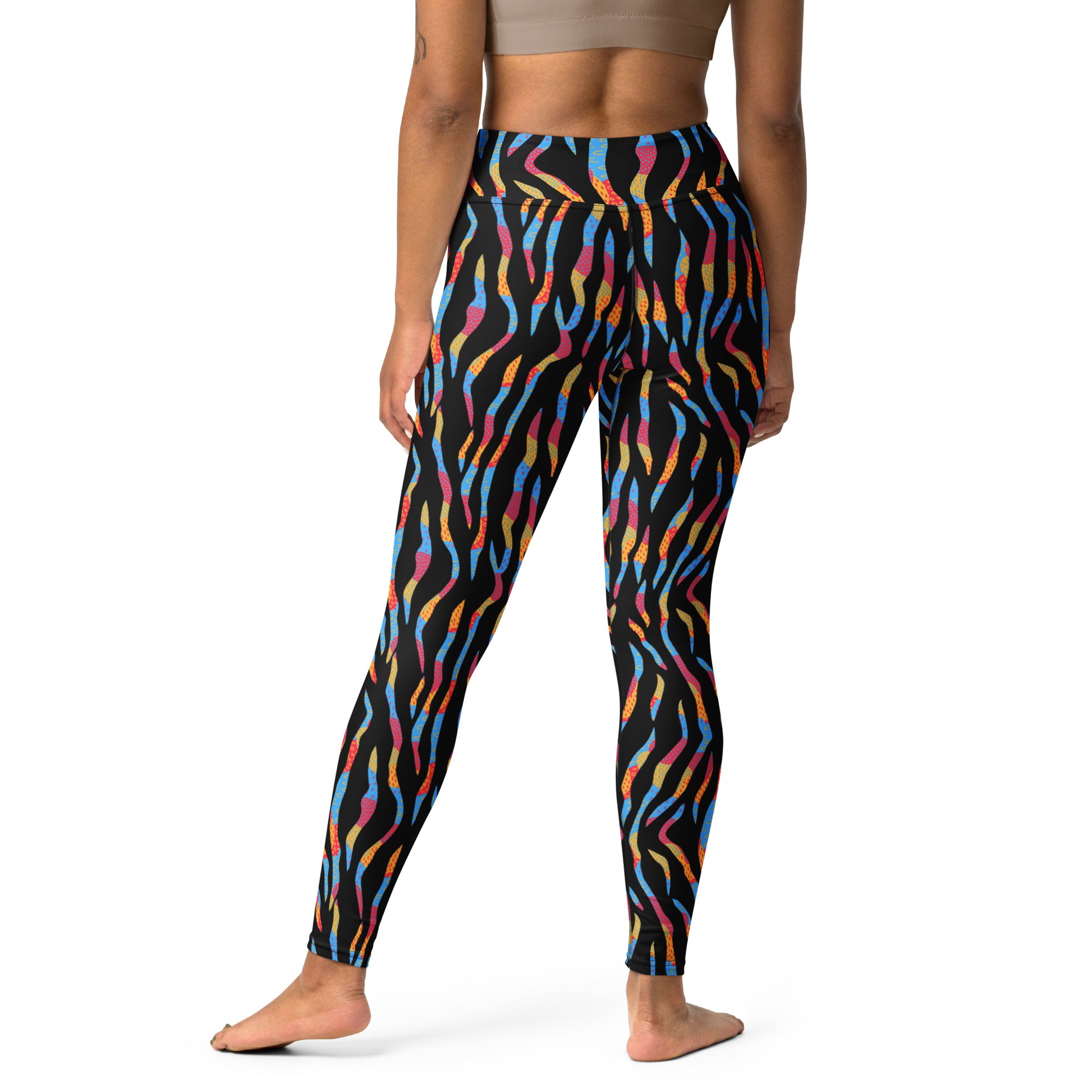A model from the back wearing high-waisted leggings with a black base and a vibrant, multicolored abstract wavy pattern in blue, orange, pink, and yellow. Chic Colorful Zebra Print Yoga Leggings for Active Wear