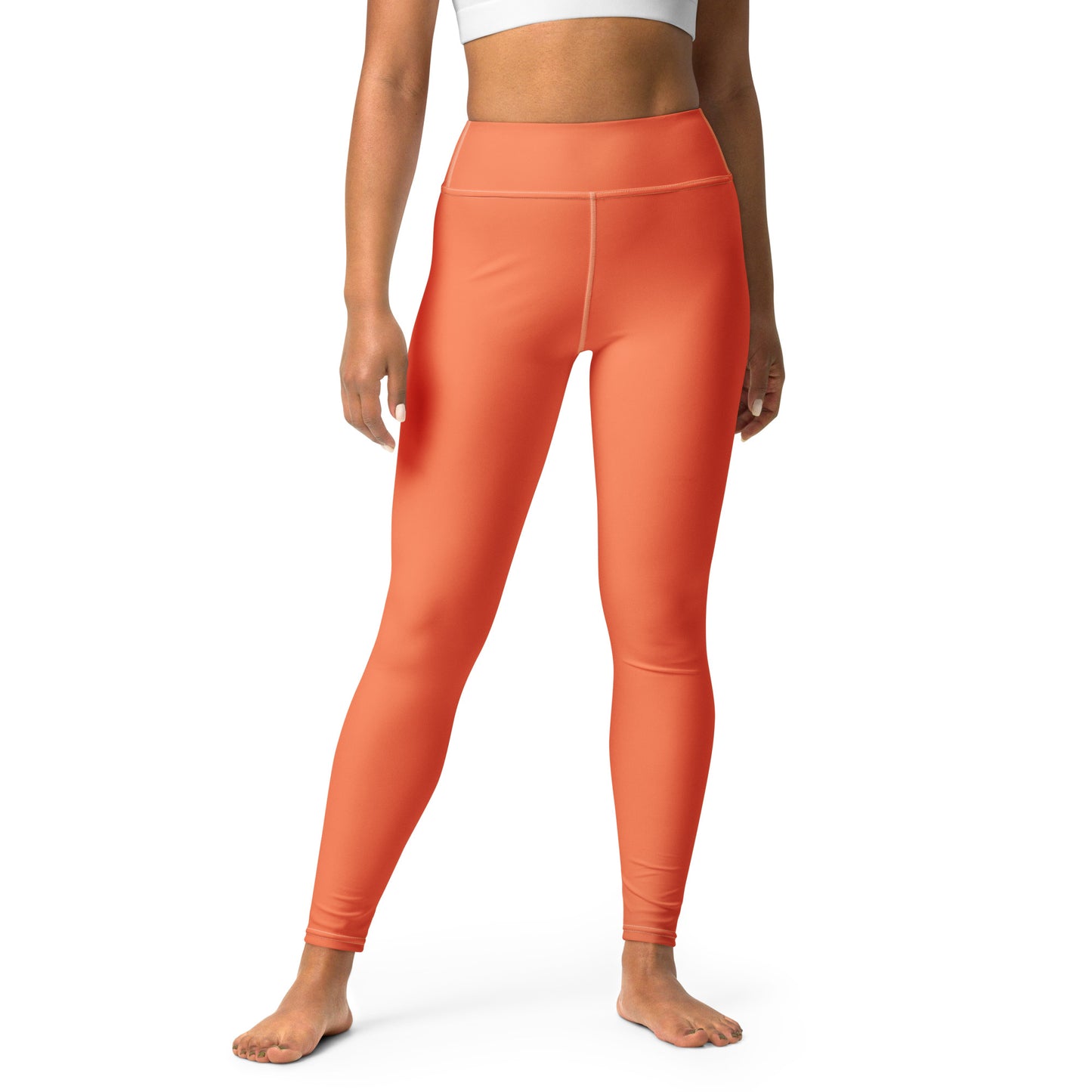 A model wearing bright orange high-waisted leggings, shown from the waist down against a plain white background. Chic Comfortable Yoga Pants in Solid Coral Shade Activewear