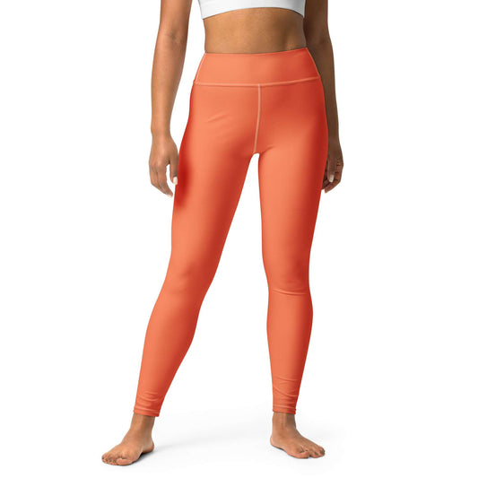 A model wearing bright orange high-waisted leggings, shown from the waist down against a plain white background. Chic Comfortable Yoga Pants in Solid Coral Shade Activewear