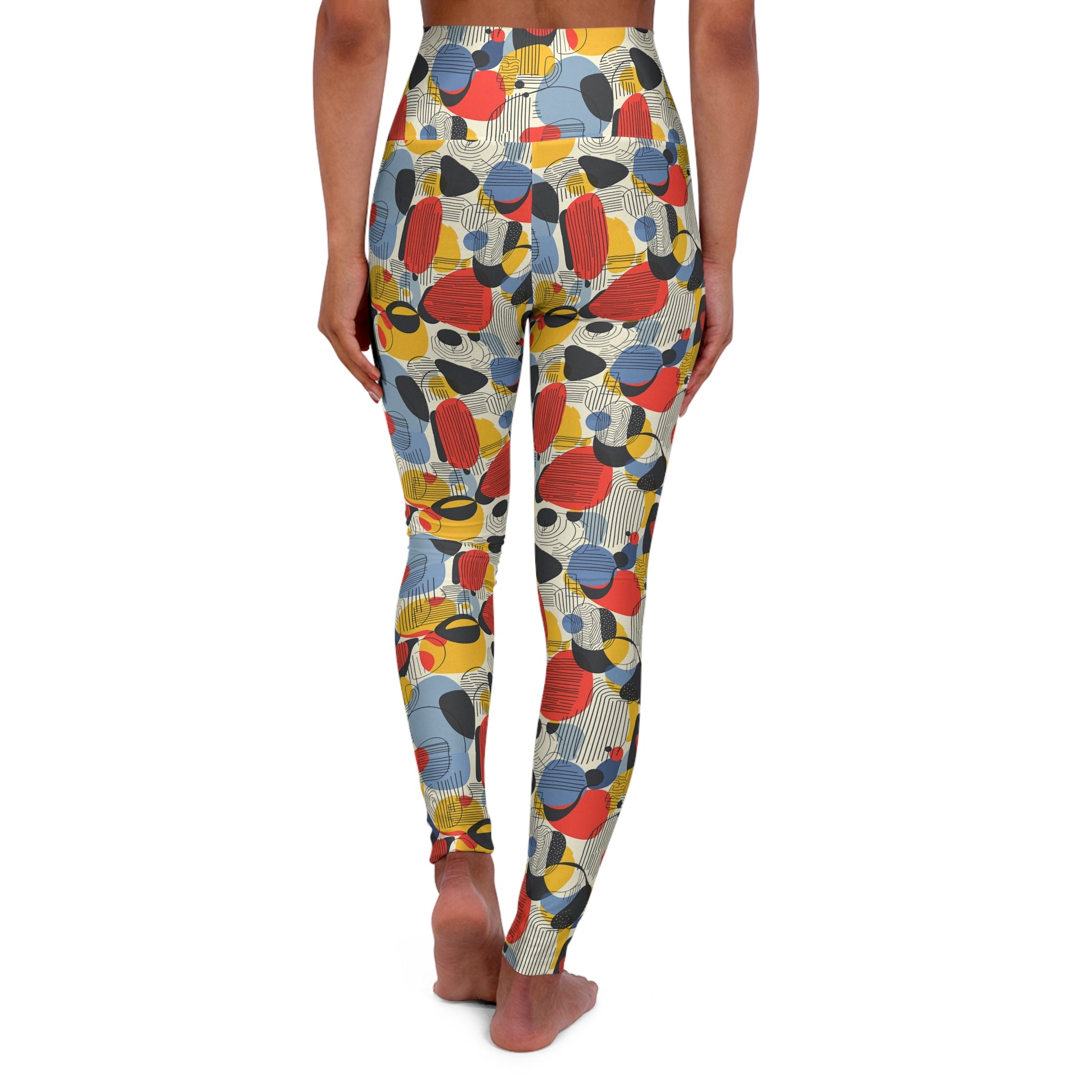 A person shown from the back wearing high-waisted leggings with an abstract multicolor print of overlapping circles and organic shapes in red, blue, yellow, black, and cream on a white background. Chic Minimalist Bauhaus Geometric Print Yoga Leggings