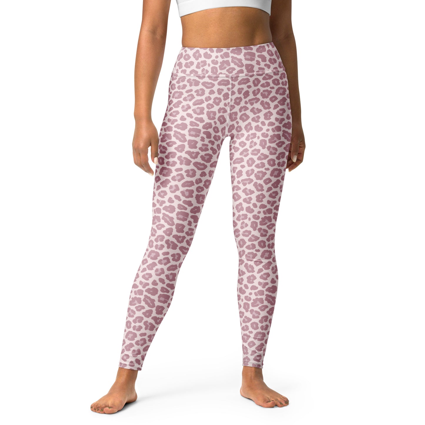 A model wearing high-waisted leggings with a dusty pink and white leopard print pattern, shown from the waist down on a white studio background. Chic Pink Leopard Pattern Pastel Yoga Leggings Activewear
