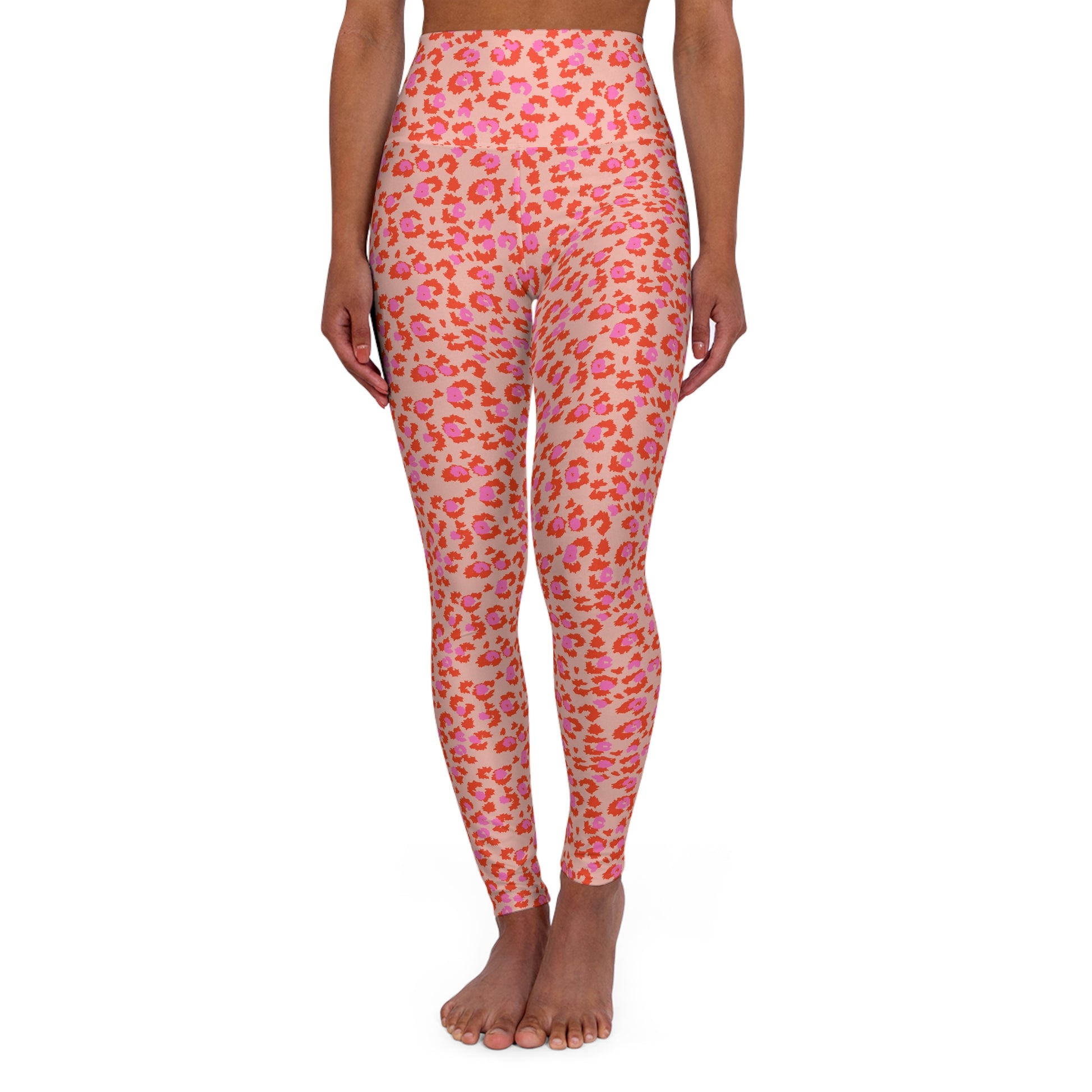 A model is shown from the waist down wearing high-waisted leggings with a pink and orange leopard print pattern on a light beige background, set against a plain white studio background. Chic Pink Leopard Print High-Waisted Yoga Leggings