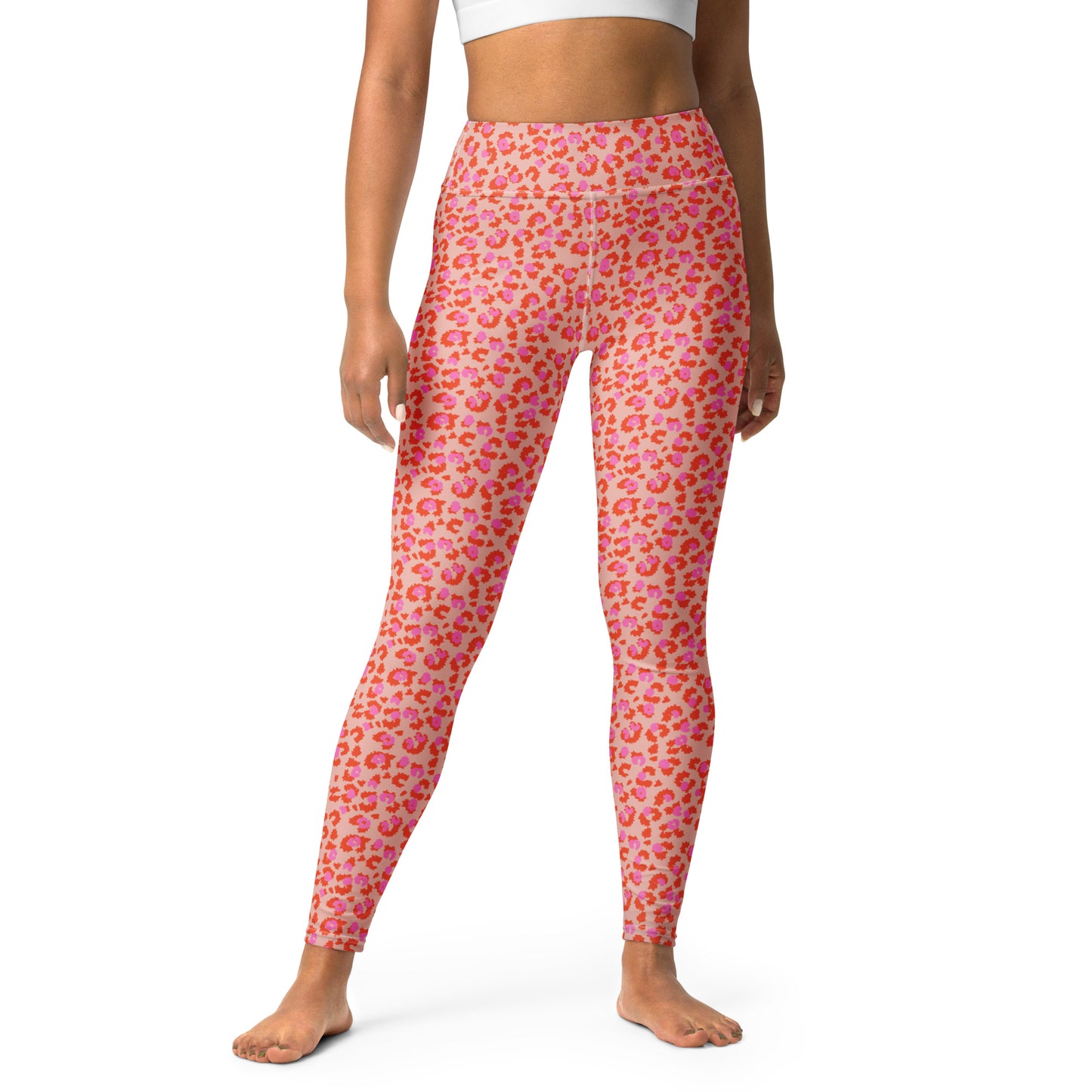 Pink leopard-print leggings with orange and yellow spots, modeled on a person against a plain white background. Chic Pink Leopard Print Yoga Pants for Workouts