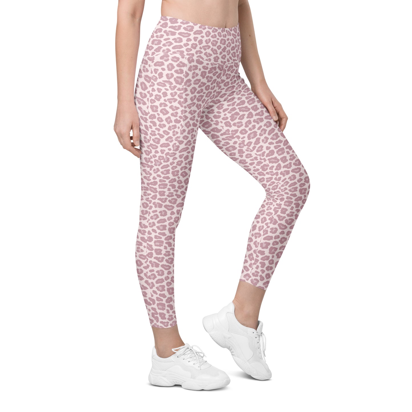 A model wearing high-waisted leggings with a pink and white leopard print pattern, paired with white sneakers, shown from the waist down on a solid white background. Chic Pink Pastel Leopard Print Leggings with Pockets Activewear
