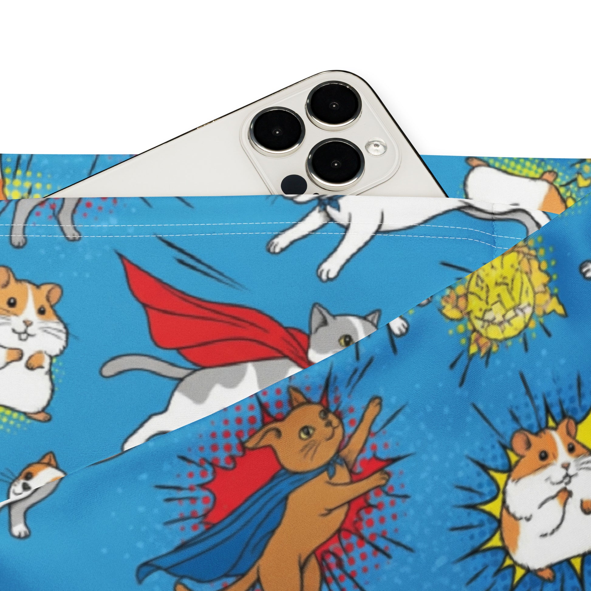 A close-up of a blue fabric product printed with cartoon cats and hamsters in superhero costumes, with a white smartphone placed on top to show scale. Chic Whimsical Superhero Pets Printed Flare Leggings Activewear