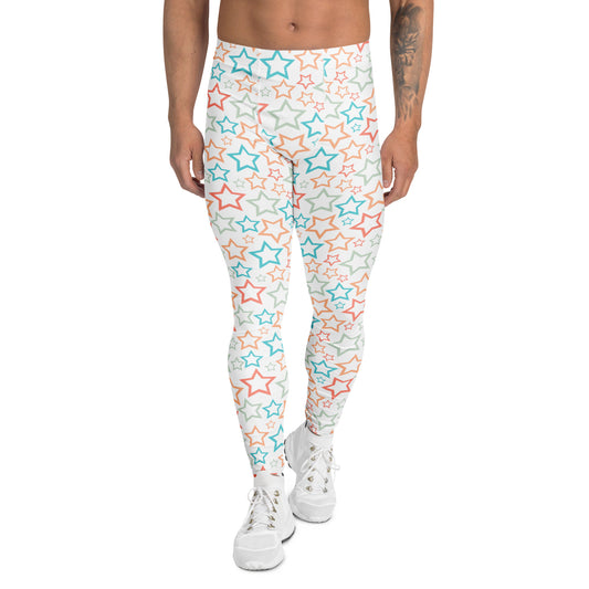 A person modeling high-waisted leggings with an all-over star print in light blue, coral orange, and gray on a white background, paired with white sneakers against a plain white studio backdrop.