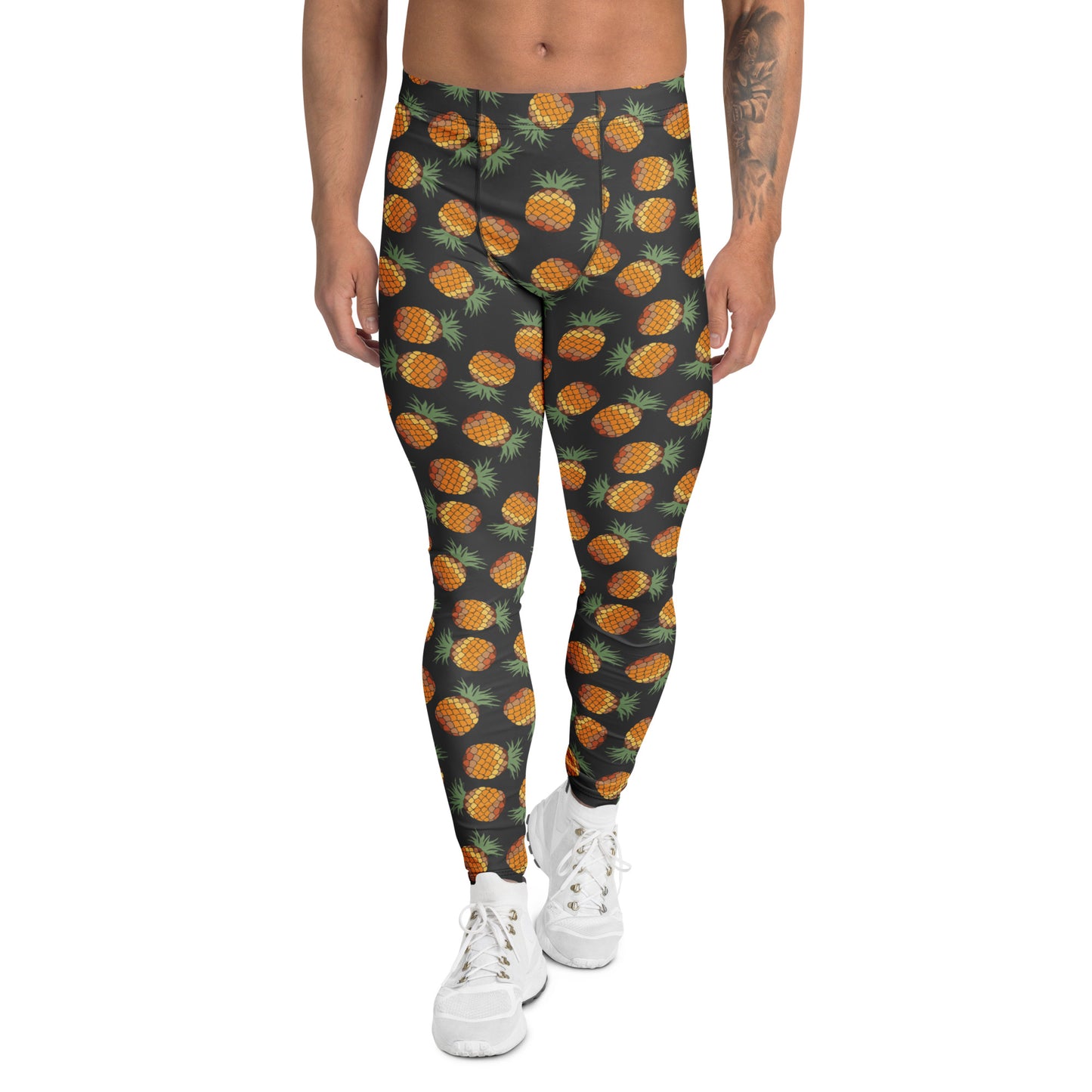 A person modeling high-waisted leggings with an all-over pineapple print on a dark charcoal background, paired with white sneakers against a plain white studio background.