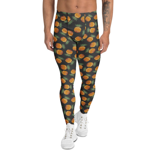 A person modeling high-waisted leggings with an all-over pineapple print on a dark charcoal background, paired with white sneakers against a plain white studio background.