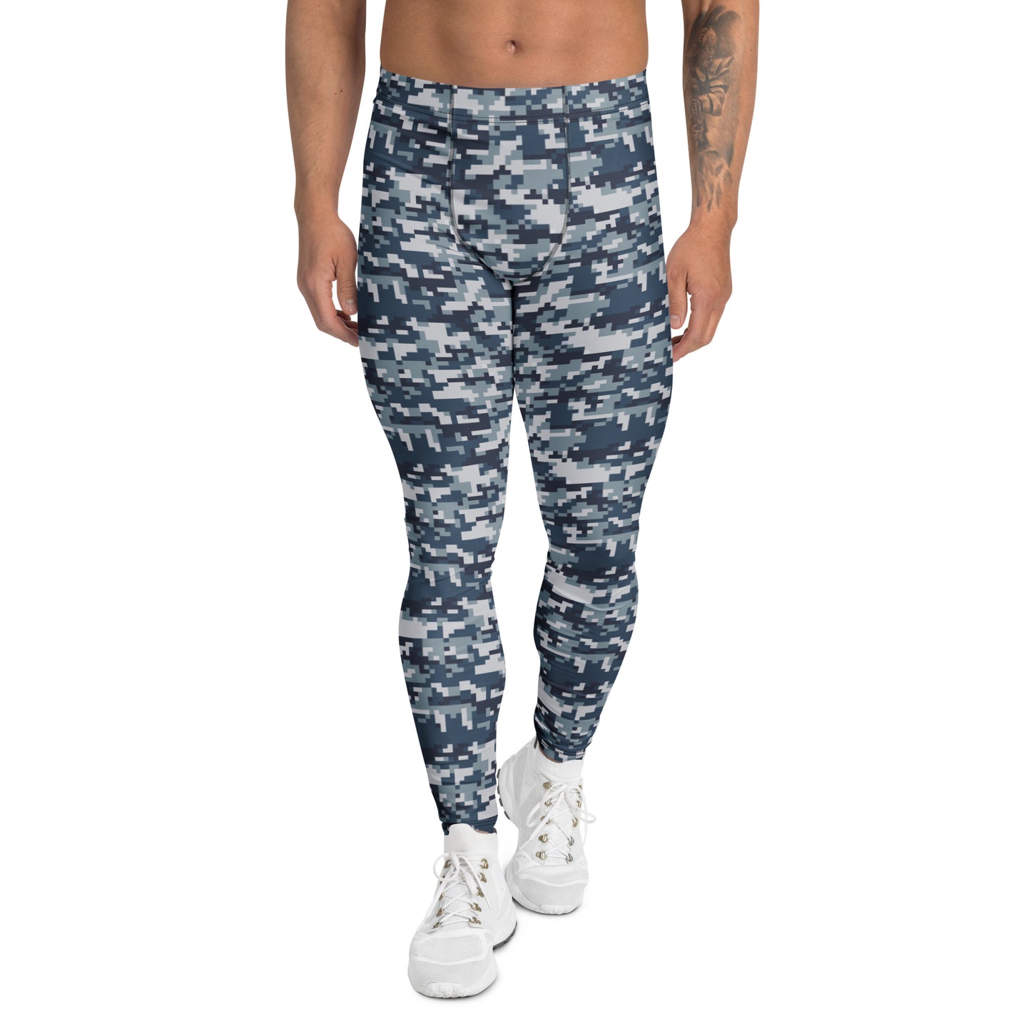 A person modeling slim-fit jogger pants with a blue and gray digital camouflage pattern, paired with white sneakers, against a plain white background.
