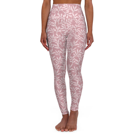 A model wearing high-waisted leggings with a dusty pink and white leaf pattern, shown from the waist down against a plain white background.