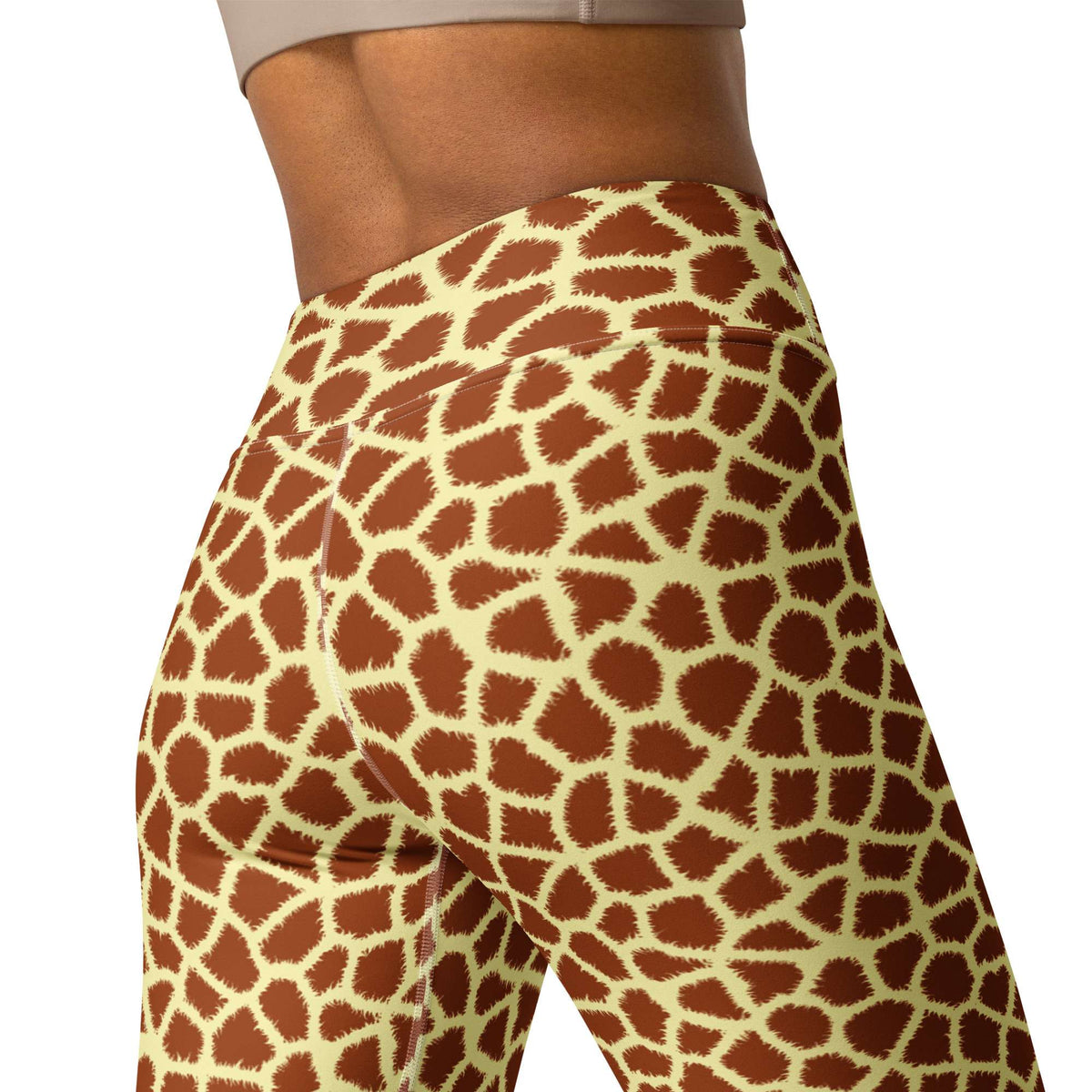 Rear view of a person wearing high-waisted leggings with a giraffe print pattern in brown and cream, against a plain white background. Comfortable Stylish Giraffe Print Yoga Pants for Active Wear