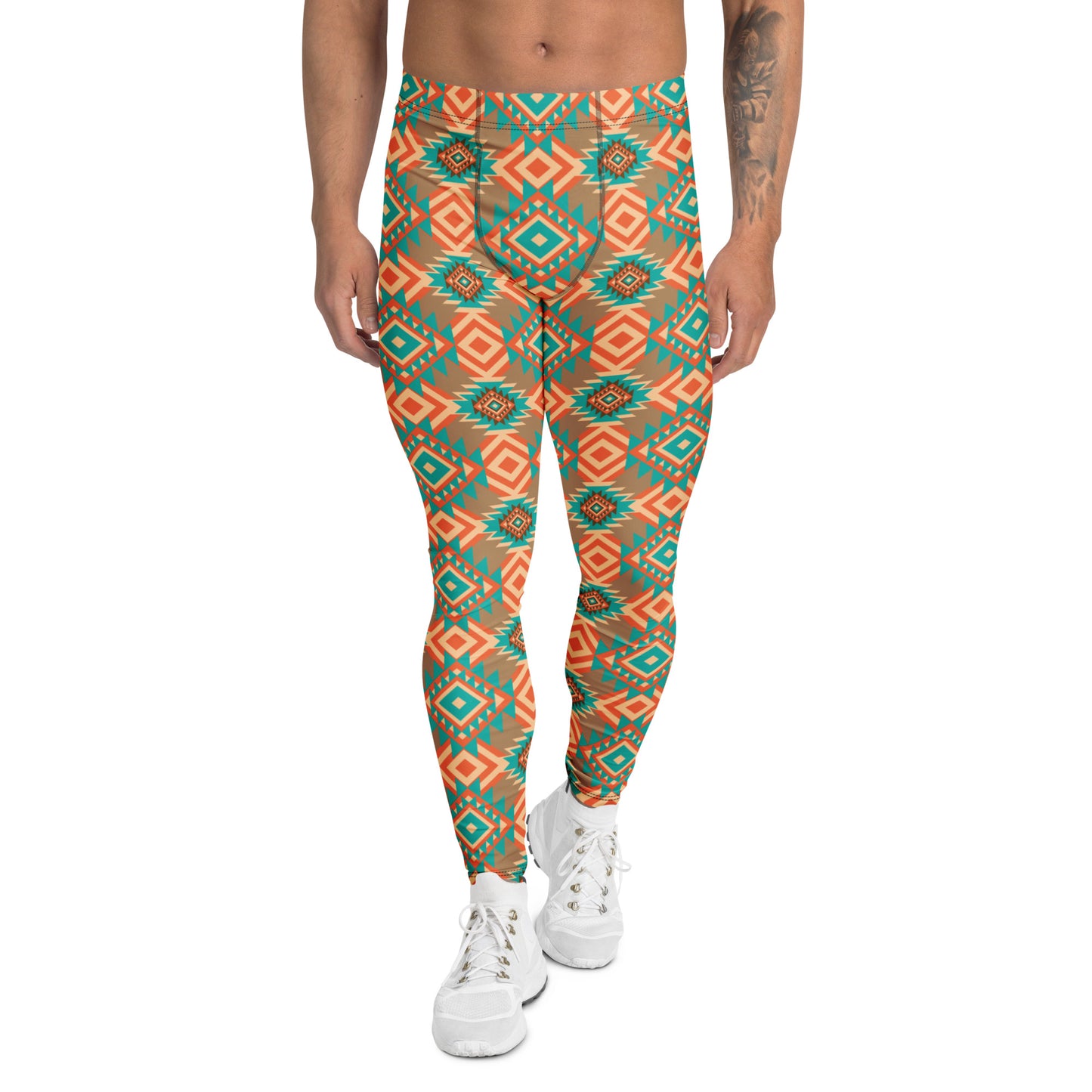 A person modeling patterned leggings with a geometric Southwestern design in teal, orange, and black, paired with white sneakers against a plain white background.