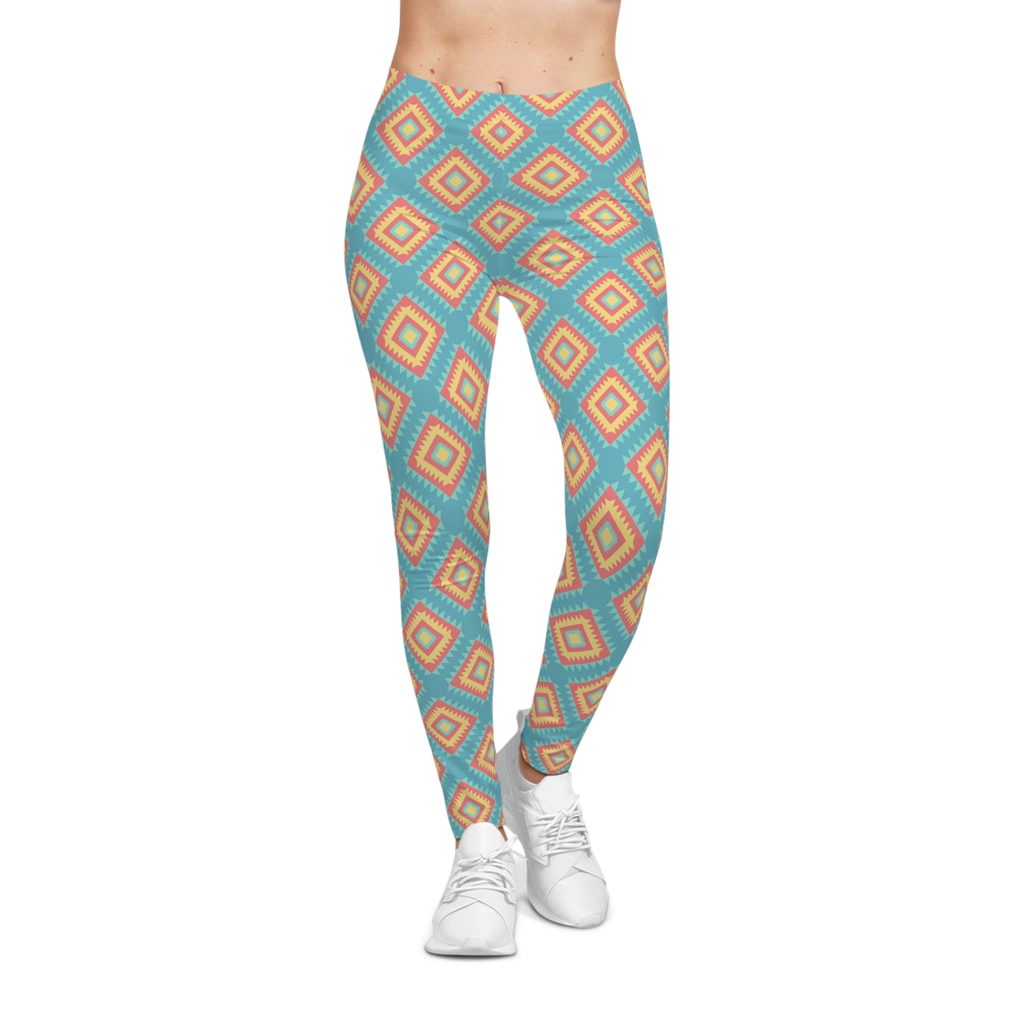 A person wearing high-waisted leggings with a repeating geometric diamond pattern in turquoise blue, orange, and beige, paired with white sneakers against a plain white background.