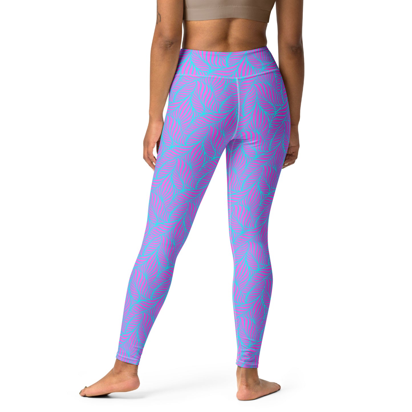 A model from the back wearing high-waisted leggings with a vibrant pink and turquoise palm leaf pattern, set against a plain white background. Contemporary Bold Neon Tropical Yoga Leggings Activewear