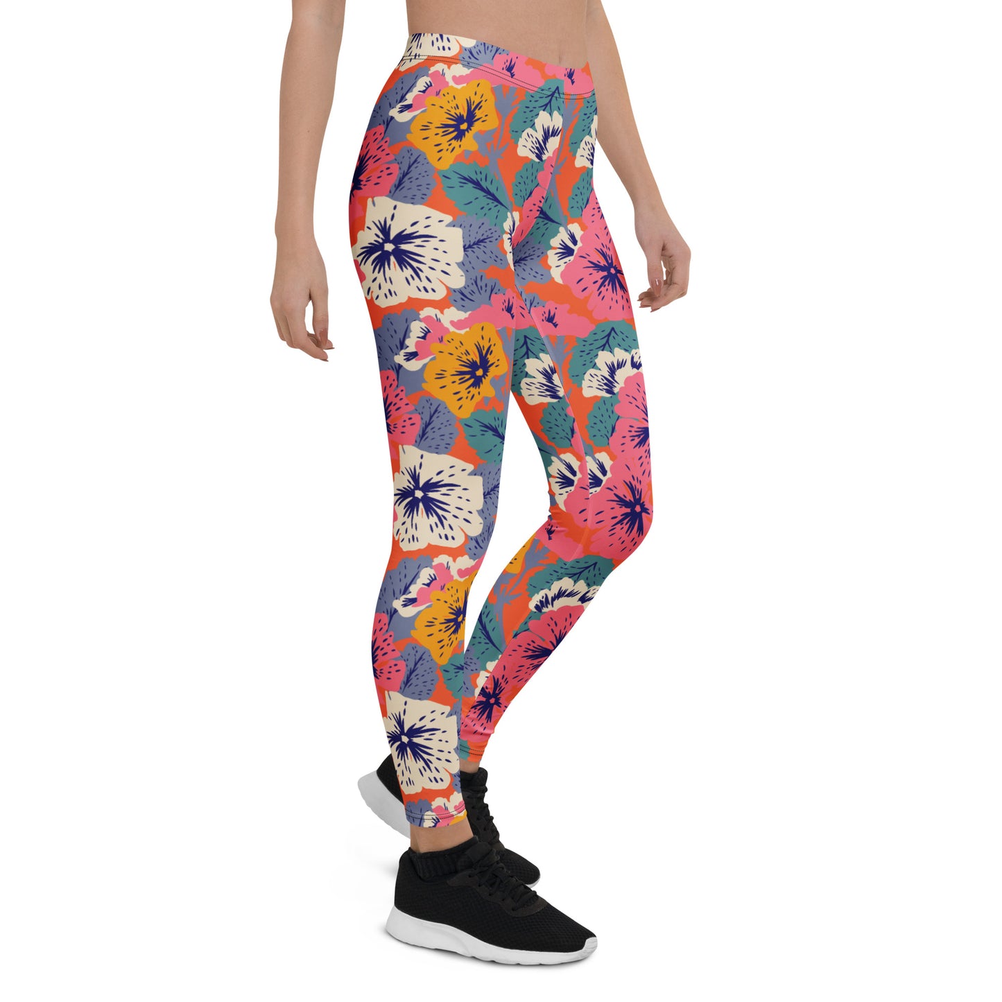 A person modeling high-waisted leggings with a colorful tropical floral and flamingo print, paired with black sneakers, against a plain white background. Contemporary Leggings with Abstract Blooming Flowers
