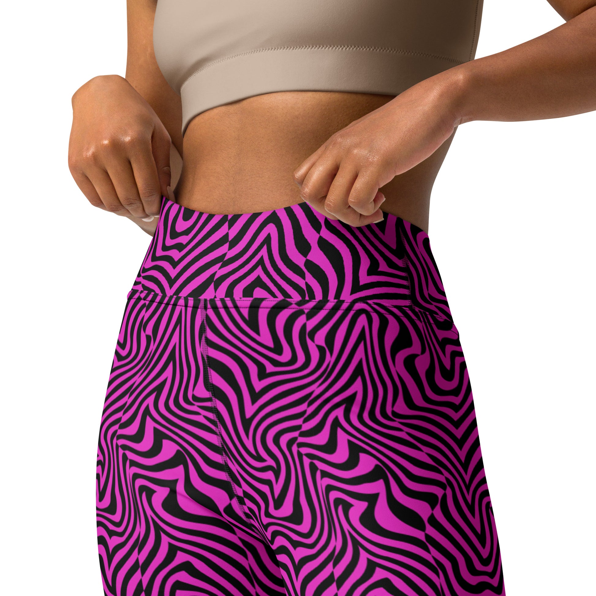 Close-up of a person wearing high-waisted leggings with a bold magenta and black wavy abstract pattern, paired with a beige sports bra against a plain white background. Cute Bold Fashion Yoga Leggings Modern Psychedelic Art Activewear