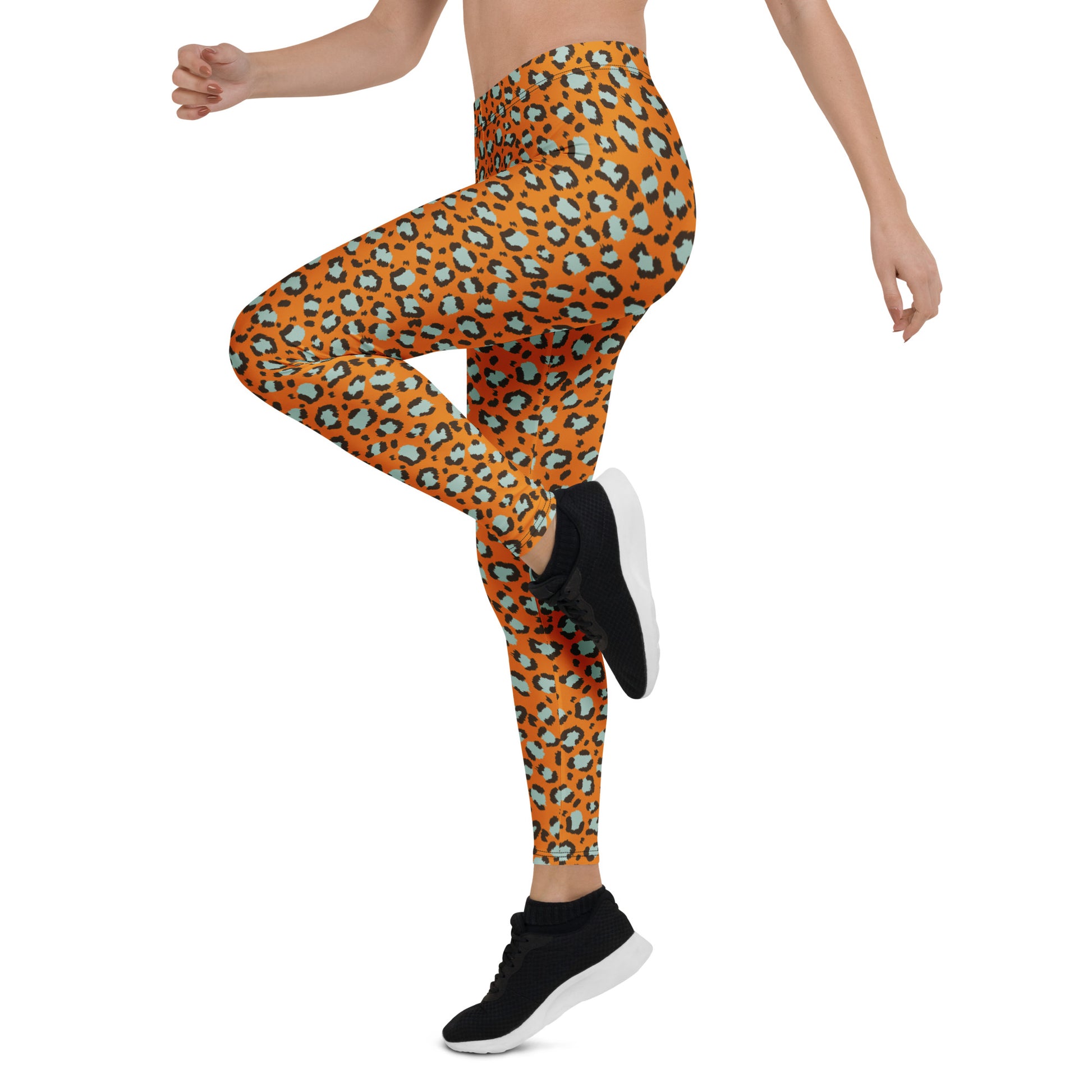 A model wearing high-waisted leggings with an orange, black, and teal leopard print, paired with black athletic sneakers, shown from the waist down on a white background. Cute Bold Leopard Print Leggings: A Wardrobe Essential for Activewear