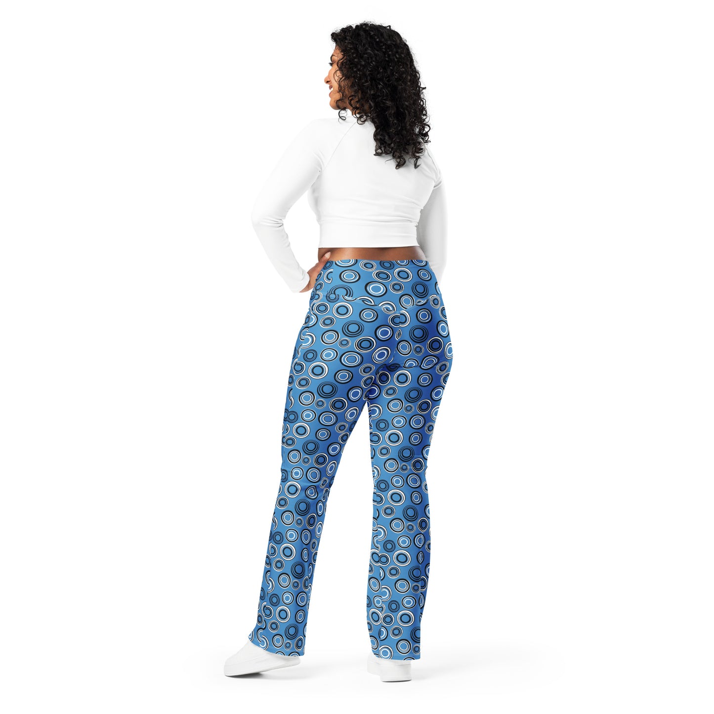 Woman wearing colorful patterned pants on a white background Cute Celestial Planetary Orbit Pattern Flare Leggings Activewear