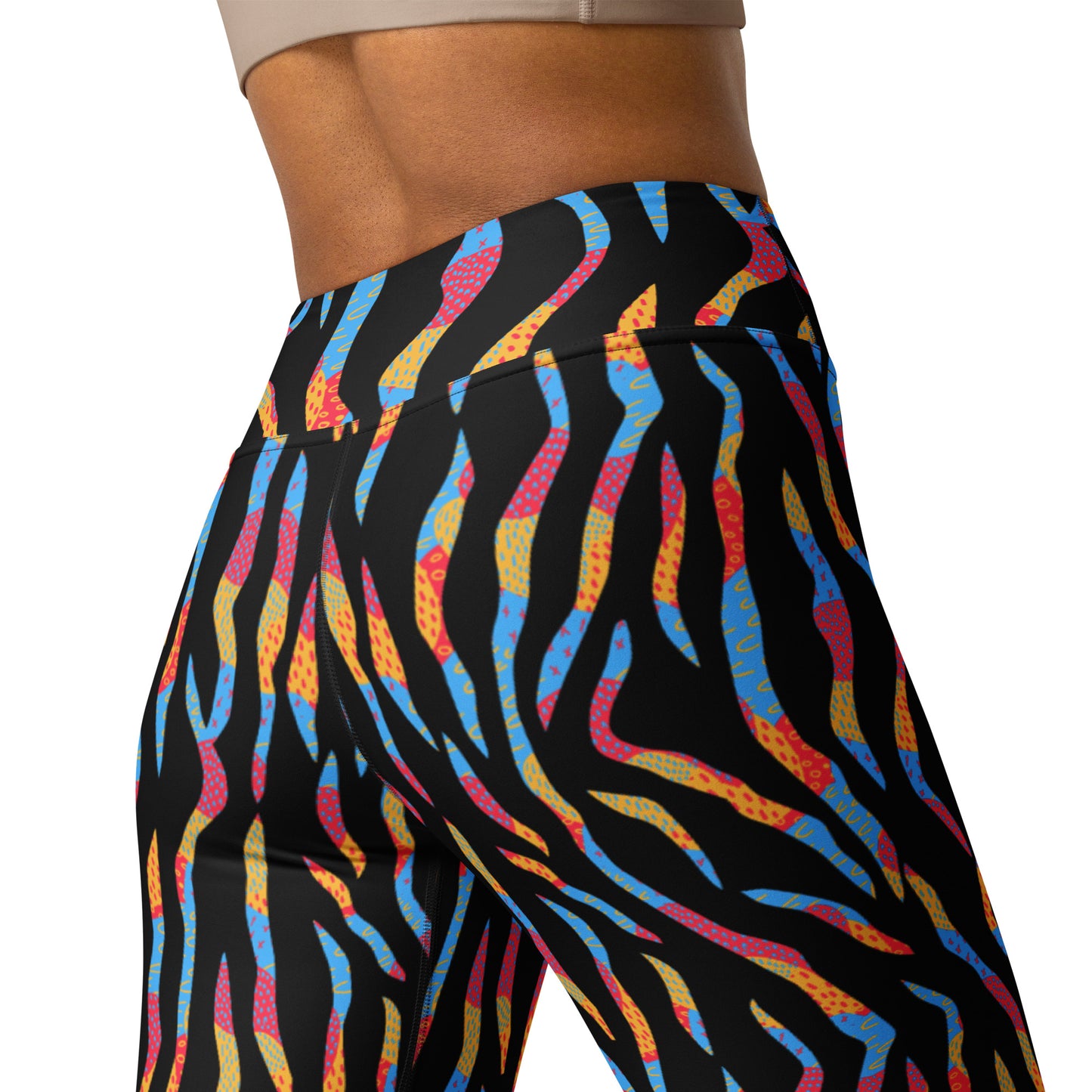 Close-up of a person wearing high-waisted leggings with a black base and a colorful abstract wavy pattern in blue, pink, orange, and yellow, shown against a plain white background. Cute Colorful Zebra Print Yoga Leggings for Active Wear