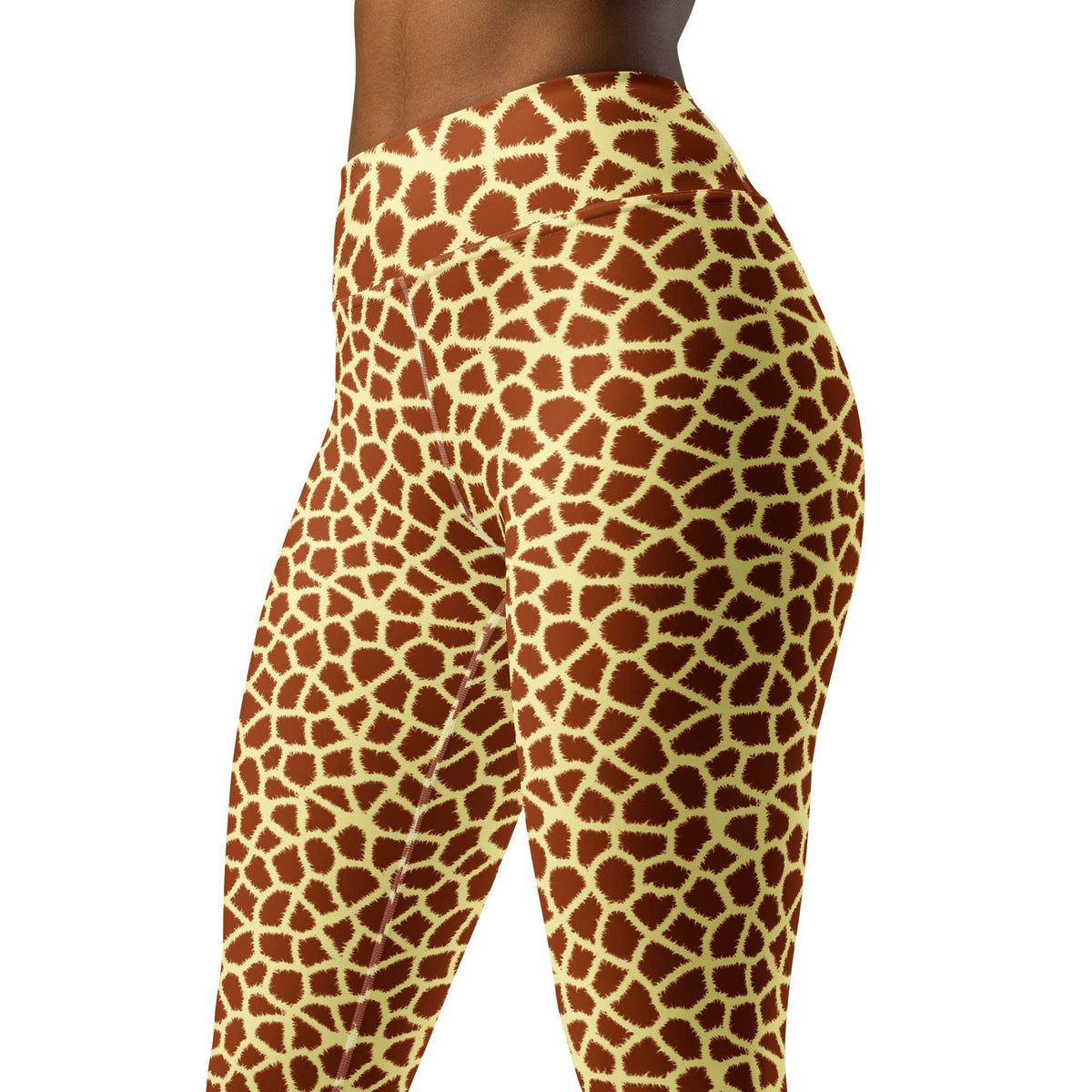 A close-up side view of a person wearing high-waisted leggings with a giraffe print pattern in brown and cream on a white background. Durable Stylish Giraffe Print Yoga Pants for Active Wear