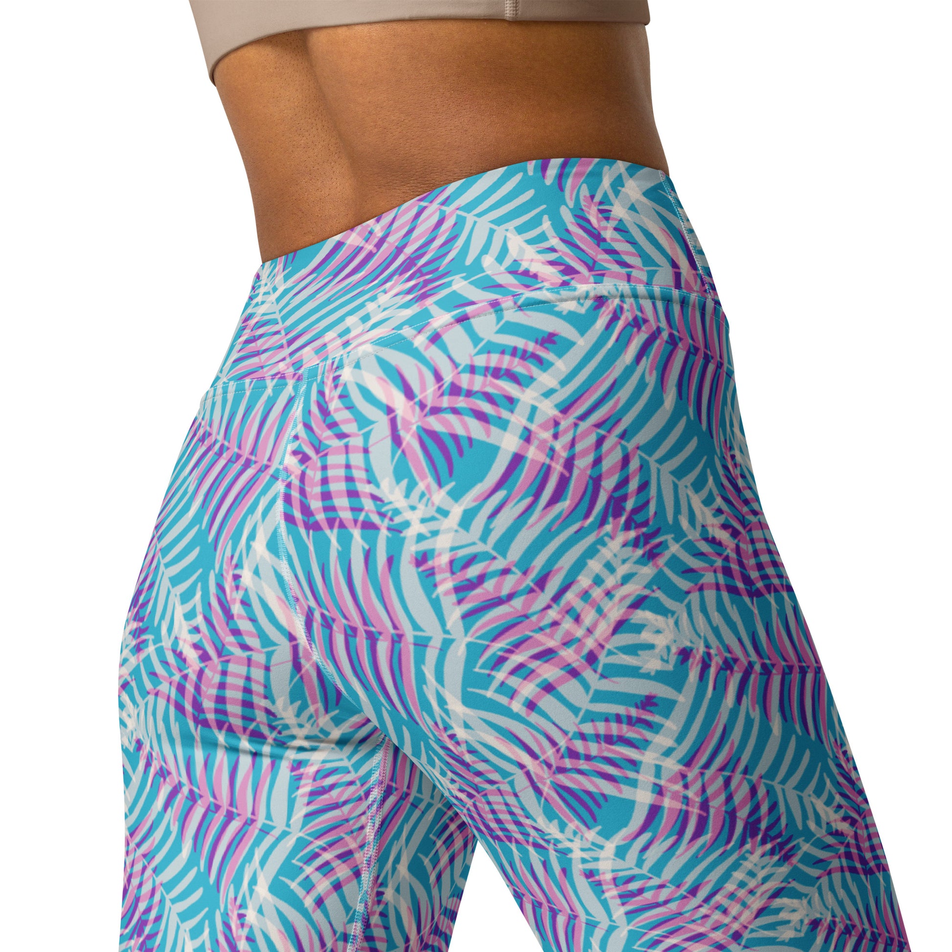 Close-up of a person wearing high-waisted athletic leggings with a tropical palm leaf print in turquoise, pink, purple, and white, shown from the side against a plain white background. Elegant Bold Pastel Palm Print Activewear Yoga Leggings