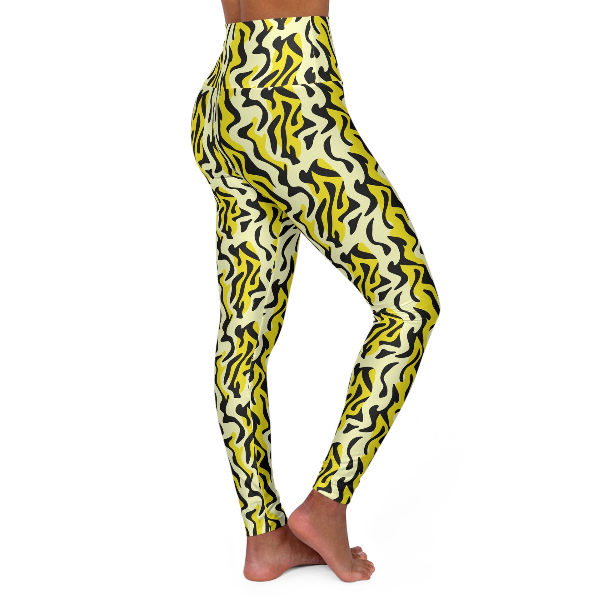 A person modeling high-waisted leggings with a bold abstract wavy pattern in yellow, black, and off-white, shown from the waist down against a plain white background. Elegant Chic Bold Yellow and Black Zebra Print Yoga Leggings Active Wear