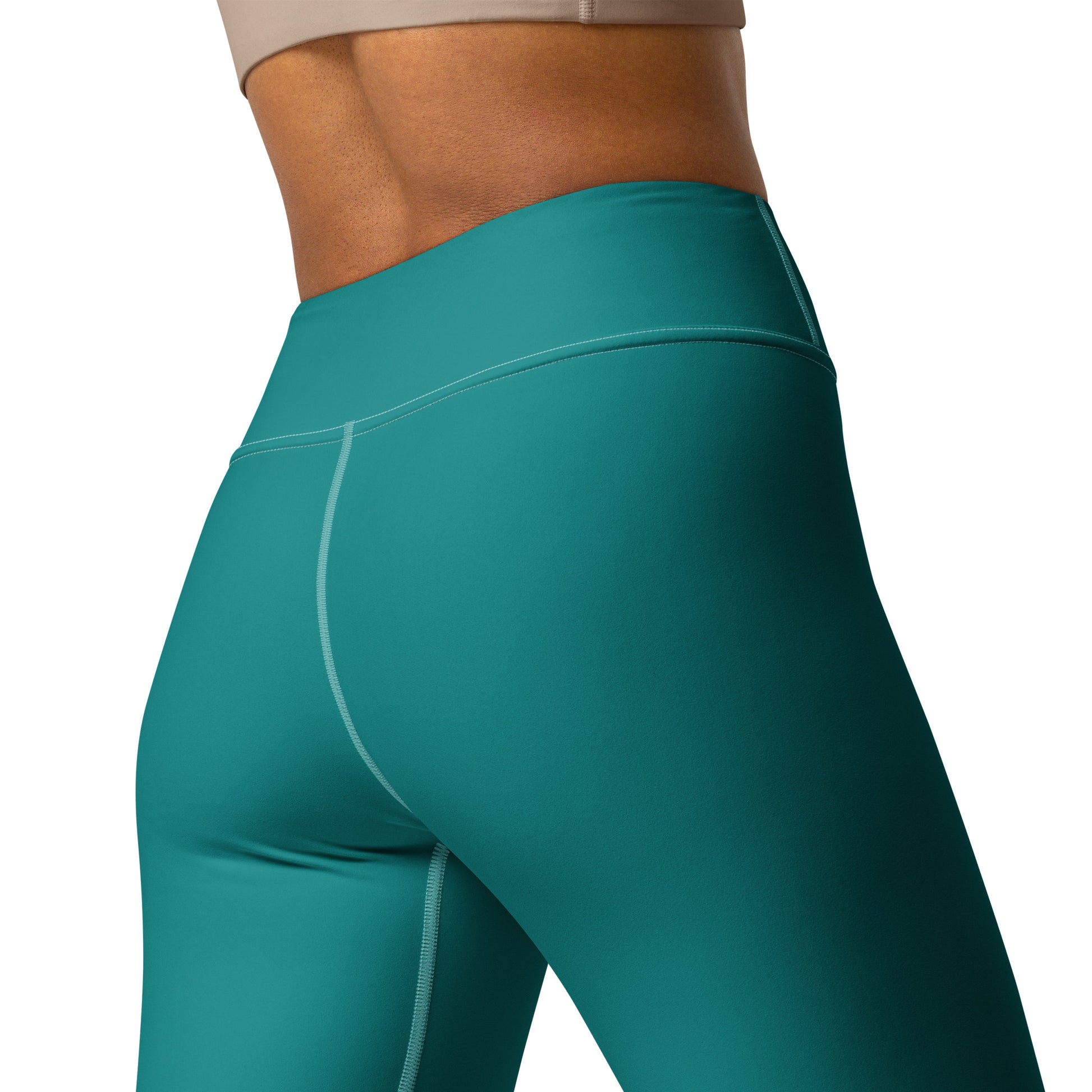 Close-up of a model wearing high-waisted teal athletic leggings, showing the waistband, hip area, and upper leg with a clean white background. Elegant Comfortable Minimalist Plain Solid Color Teal Yoga Leggings for Activewear