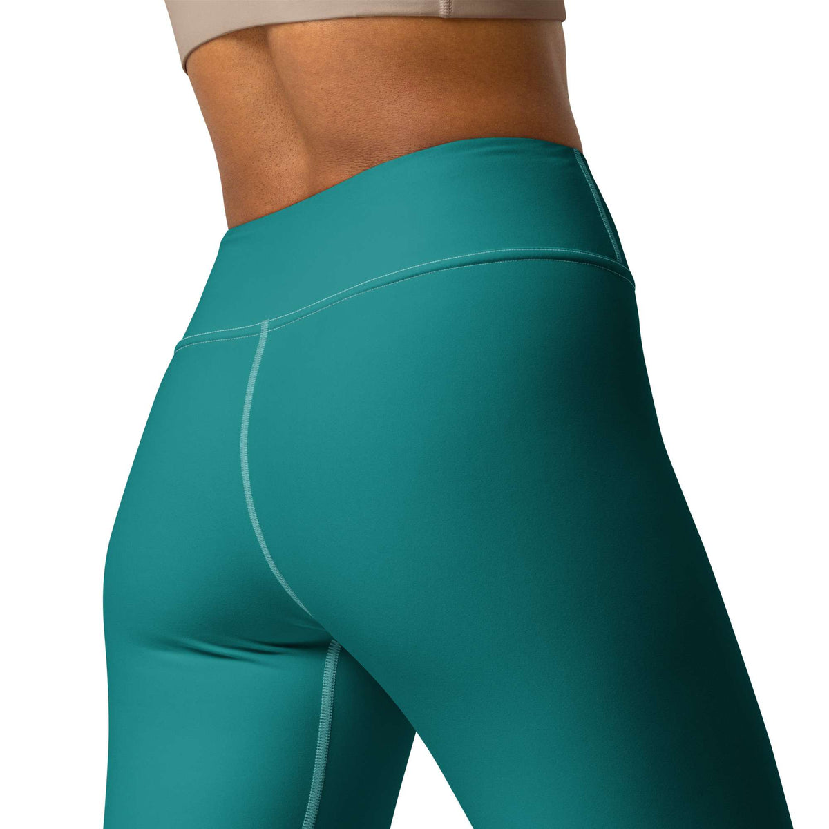 Close-up of a model wearing high-waisted teal athletic leggings, showing the waistband, hip area, and upper leg with a clean white background. Elegant Comfortable Minimalist Plain Solid Color Teal Yoga Leggings for Activewear