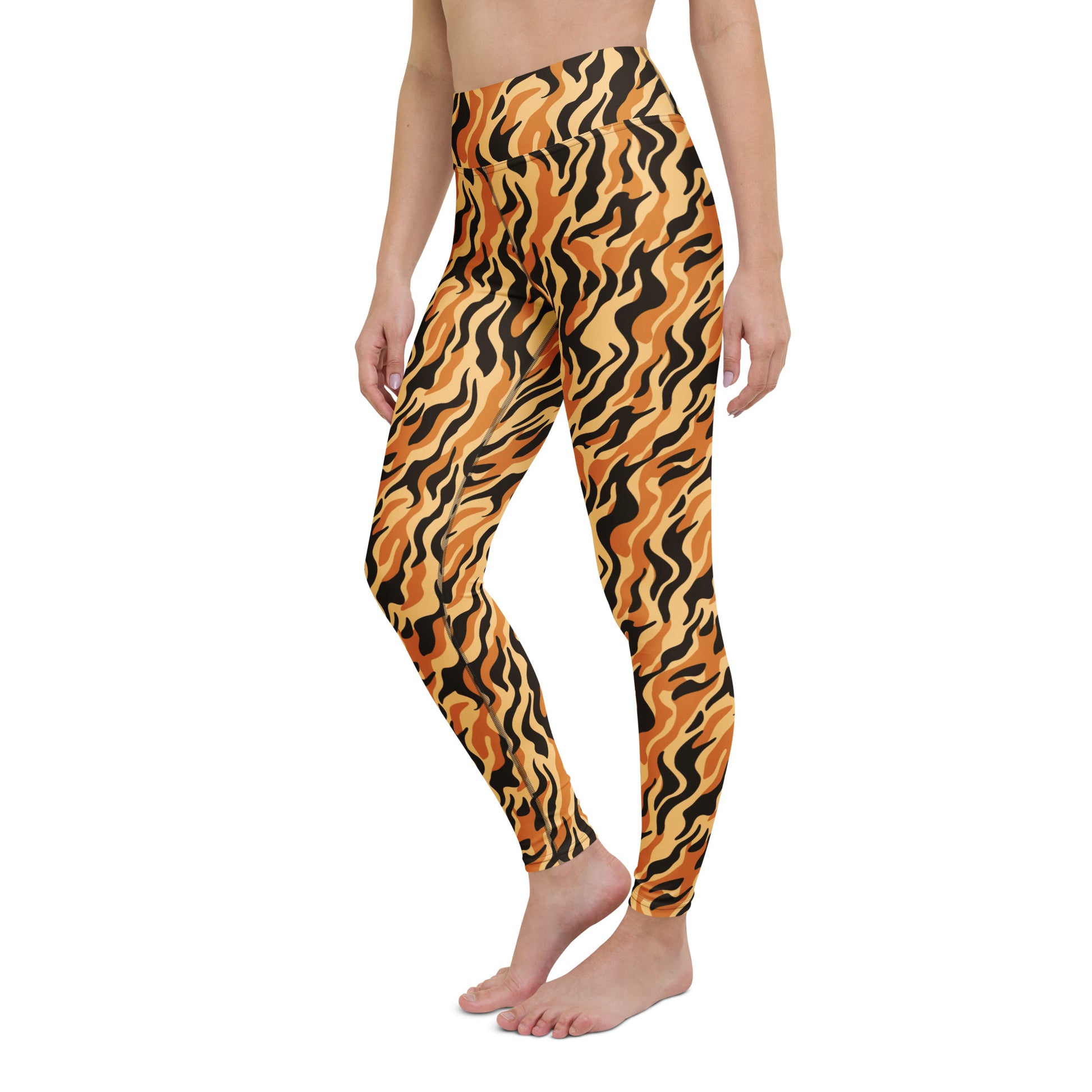 A person modeling high-waisted leggings with a bold wavy tiger-stripe pattern in orange, black, and tan against a plain white background. Elegant Yoga Leggings with Bold Tiger Print Design