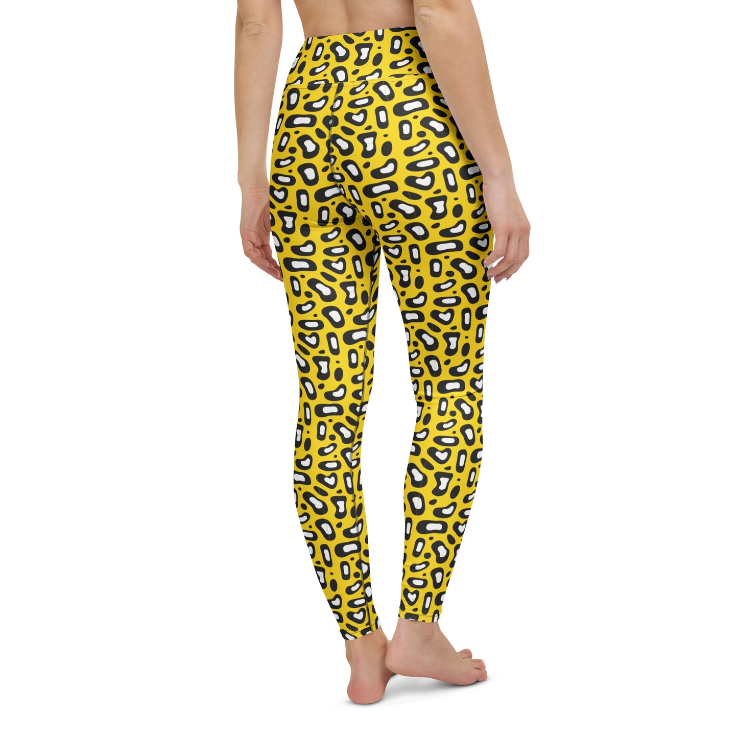 A person wearing bright yellow leggings with a black and white abstract animal-like spot pattern, shown from the back against a plain white background. Fashion-Forward Yoga Pants Comfortable Yoga Leggings Bold Yellow Leopard Skin Print Activewear