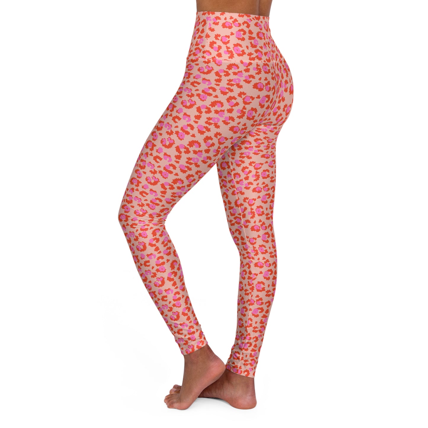 A side view of a model wearing high-waisted leggings with a pink and orange leopard print pattern on a light beige background, set against a plain white studio background. Fashionable Yoga Leggings in Pink and Leopard